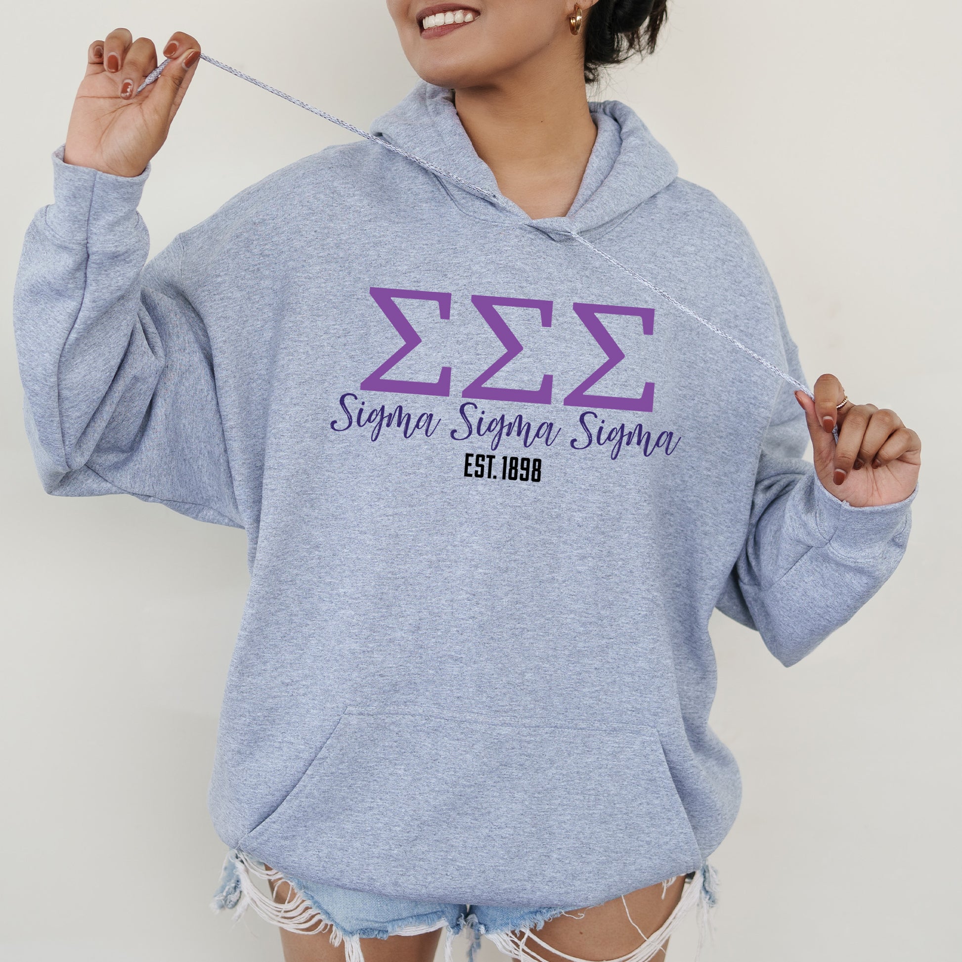a woman in a blue hoodie is holding a string