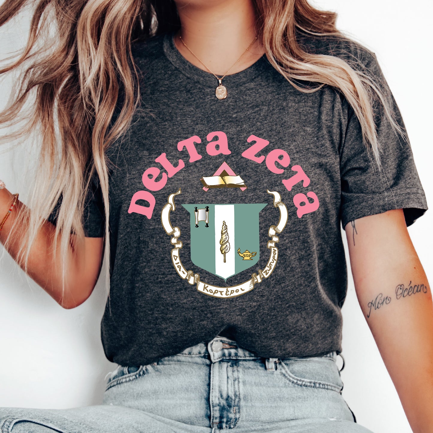 a woman wearing a t - shirt with a crest on it