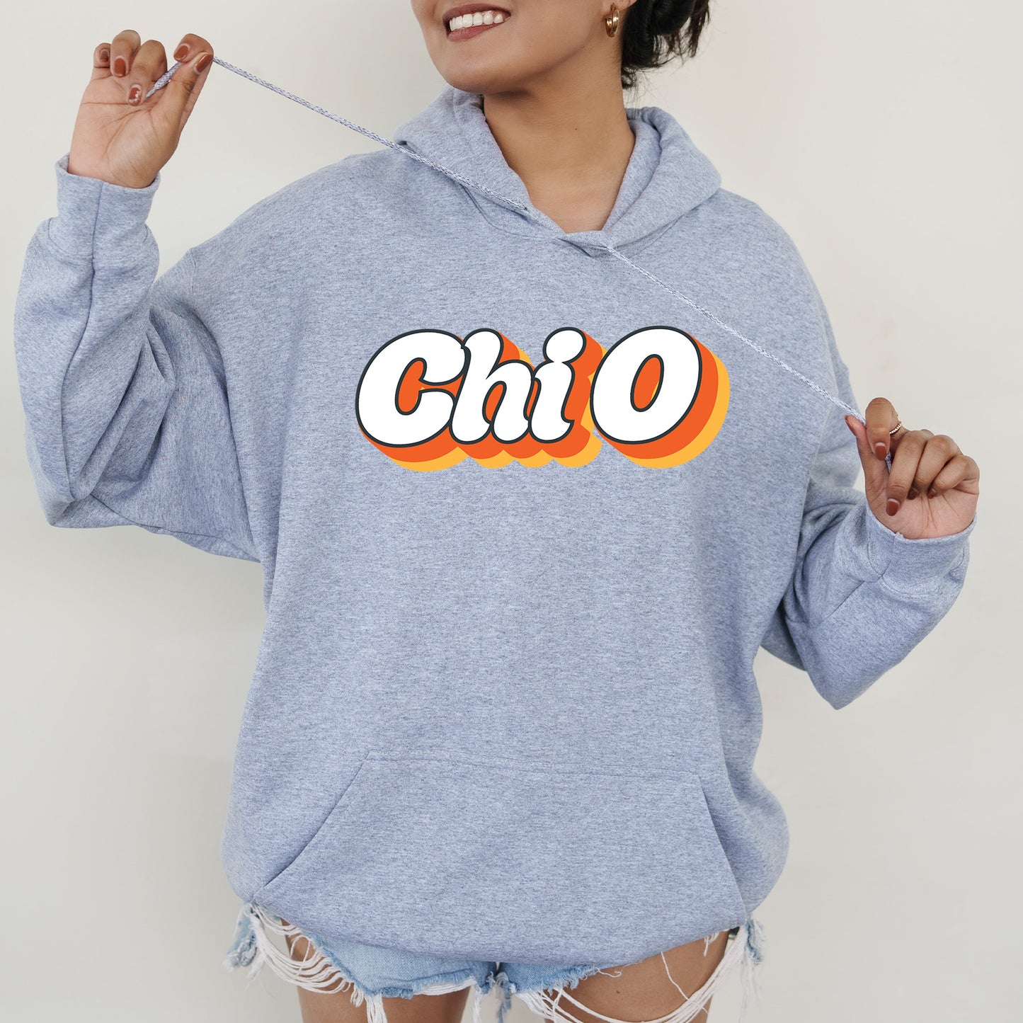 a woman wearing a blue hoodie with the word chio on it