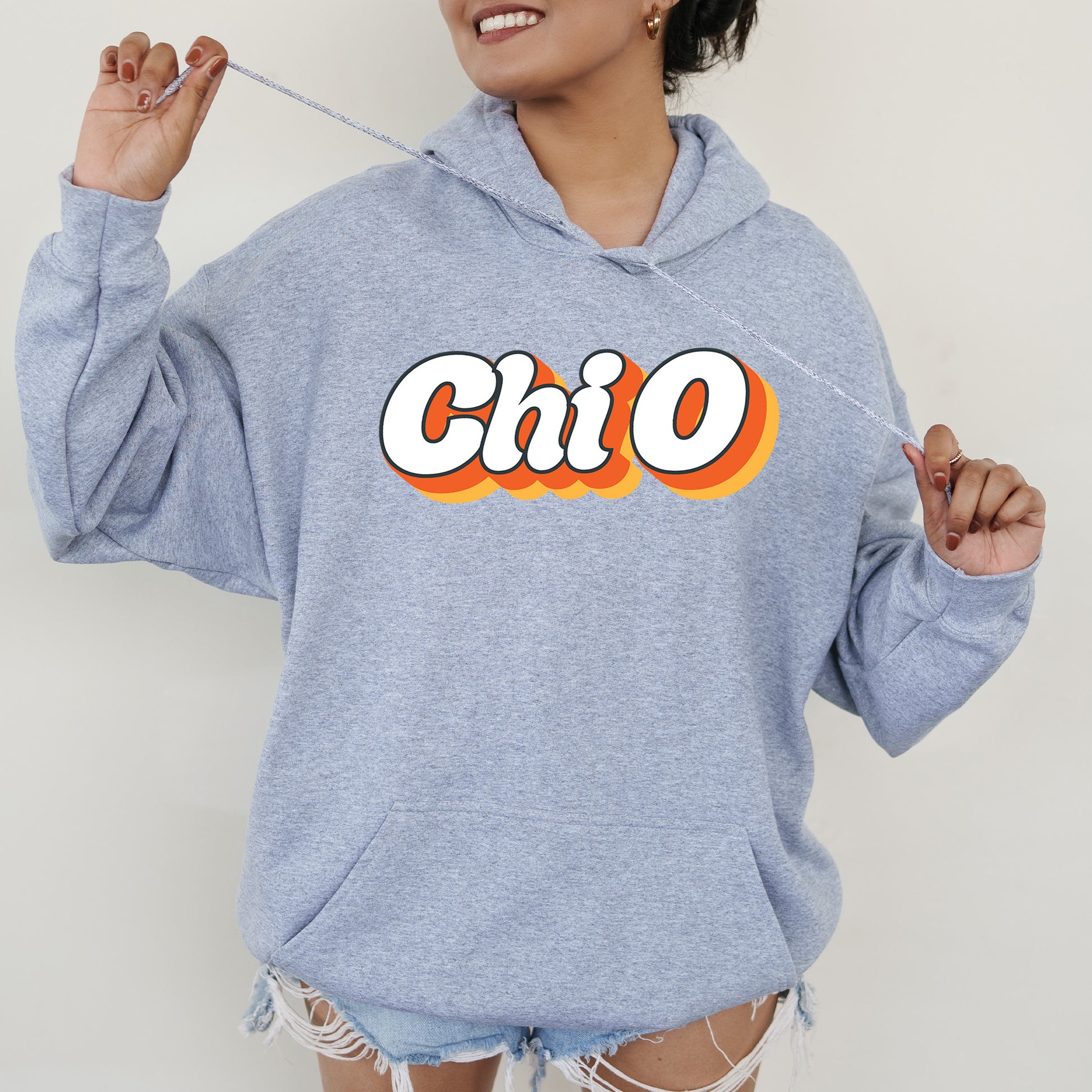 a woman wearing a blue hoodie with the word chio on it