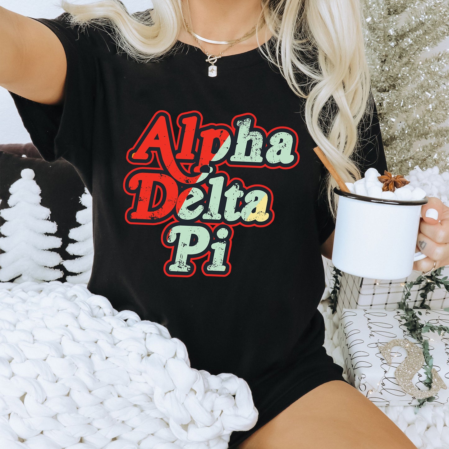 a woman sitting on a couch holding a cup of coffee