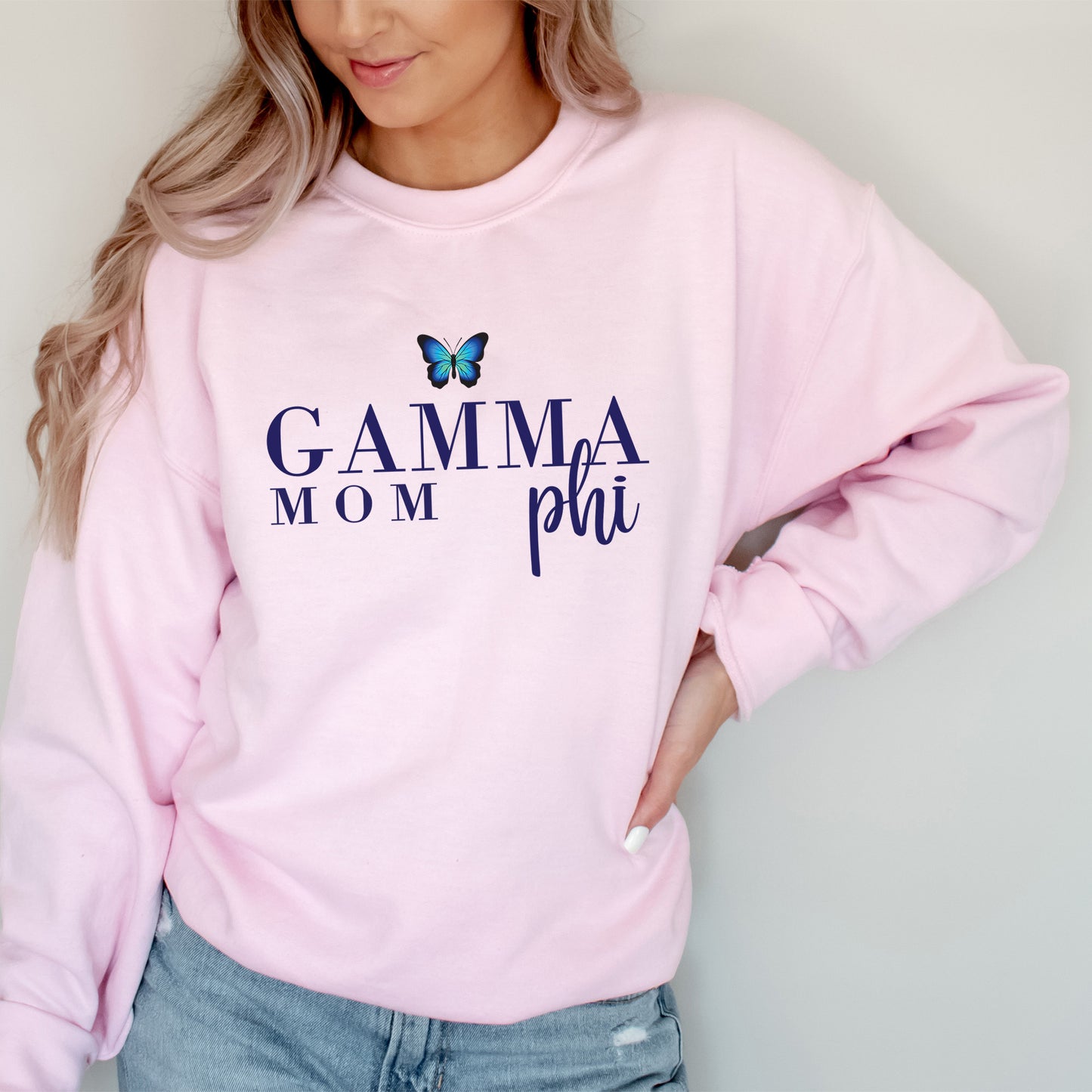 a woman wearing a pink sweatshirt with a butterfly on it