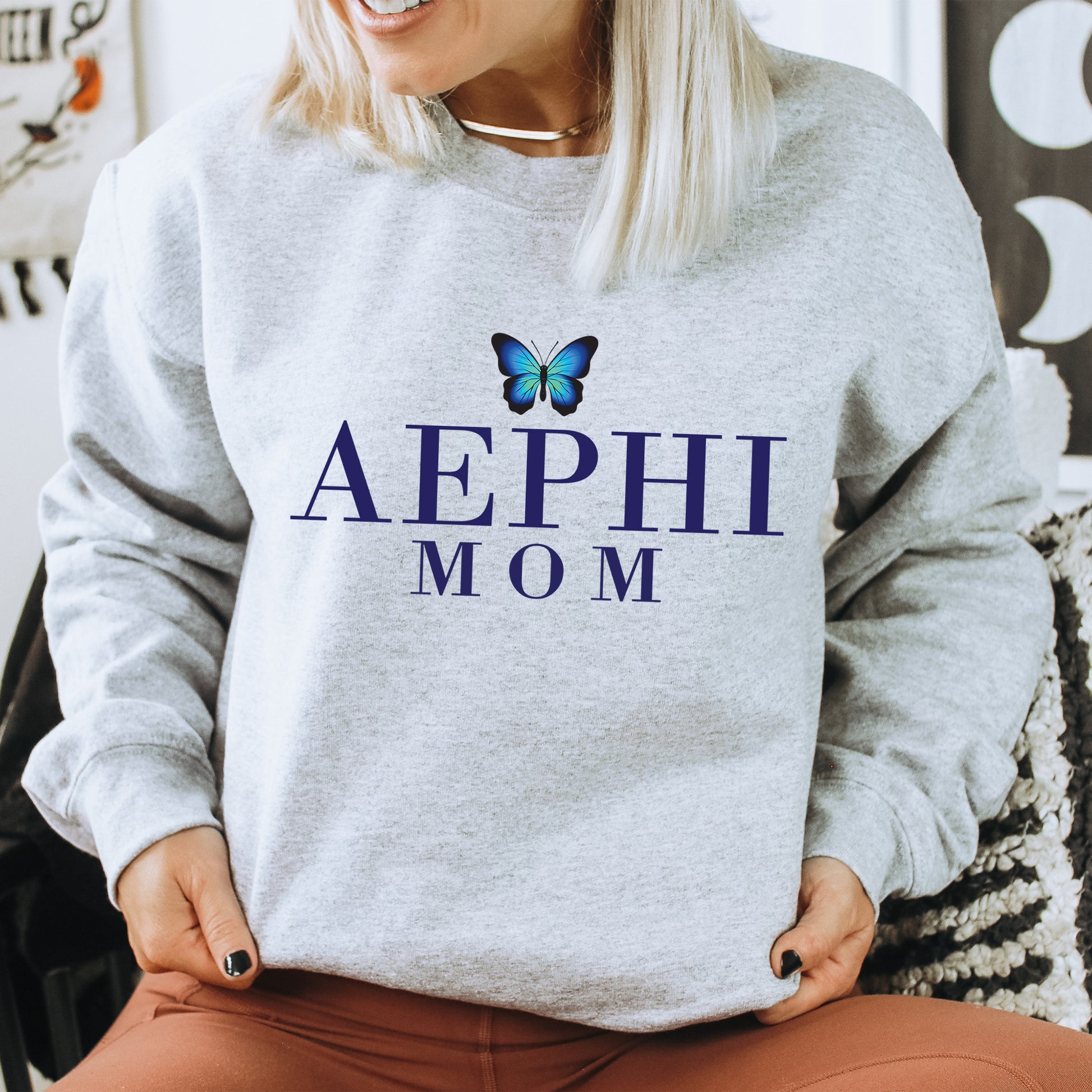 a woman wearing a sweatshirt with a butterfly on it
