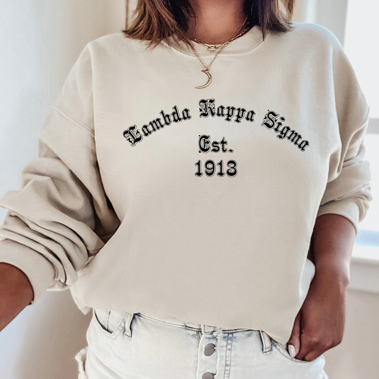 a woman wearing a white sweatshirt with a black print on it