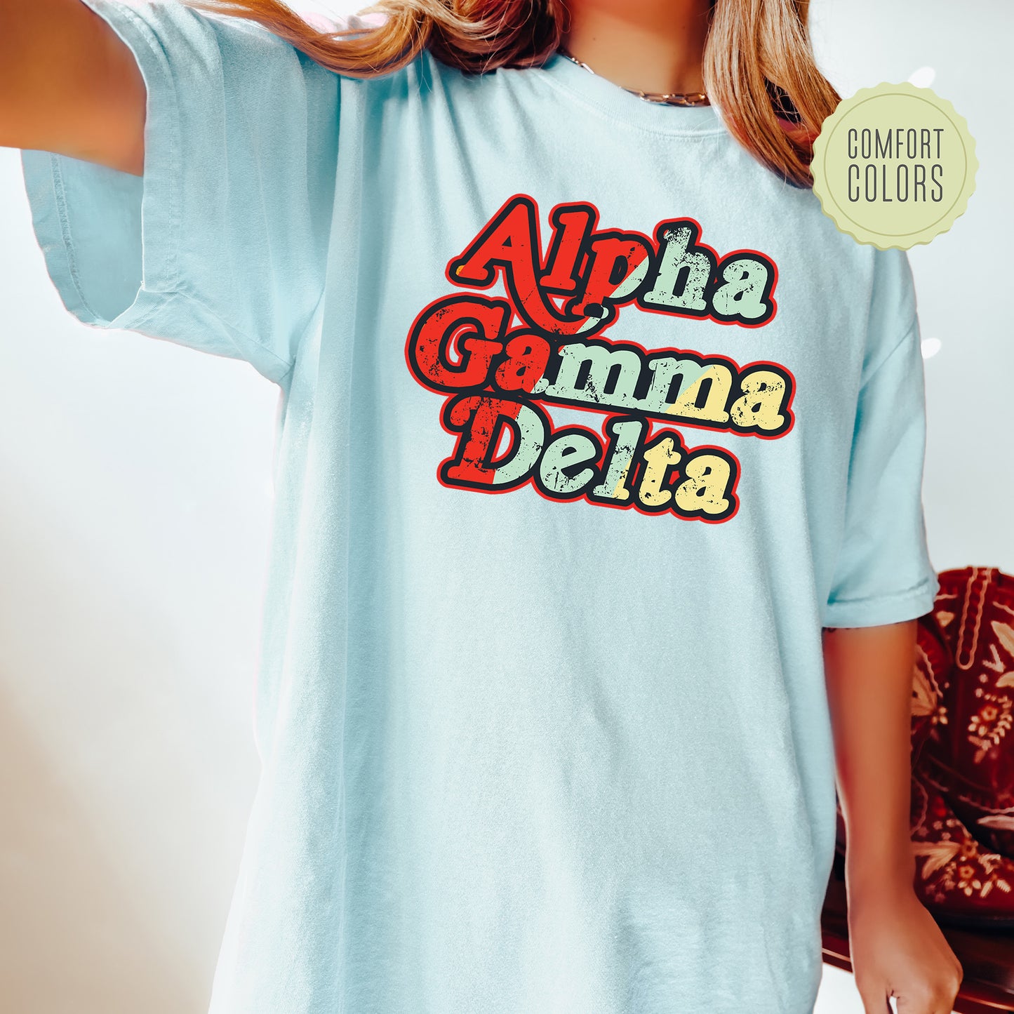 a woman wearing a light blue shirt that says aloha gama delta