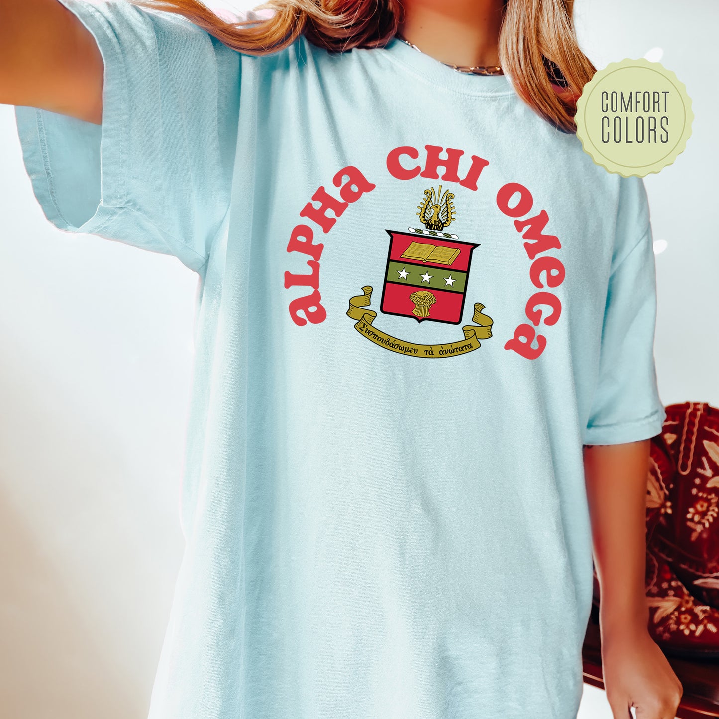 a young girl wearing a blue shirt with a crest on it