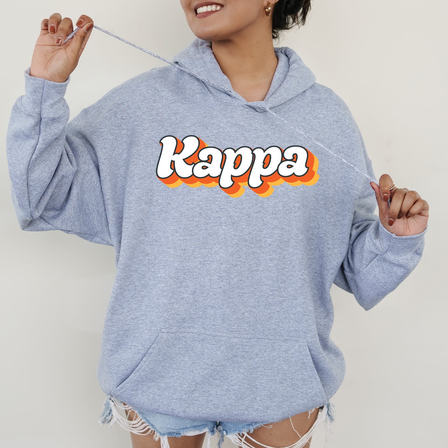 a woman wearing a blue kappa hoodie with the word kappa