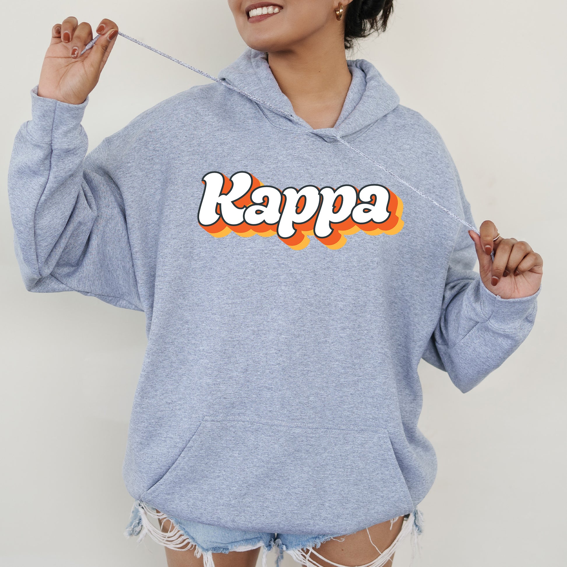 a woman wearing a blue kappa hoodie with the word kappa