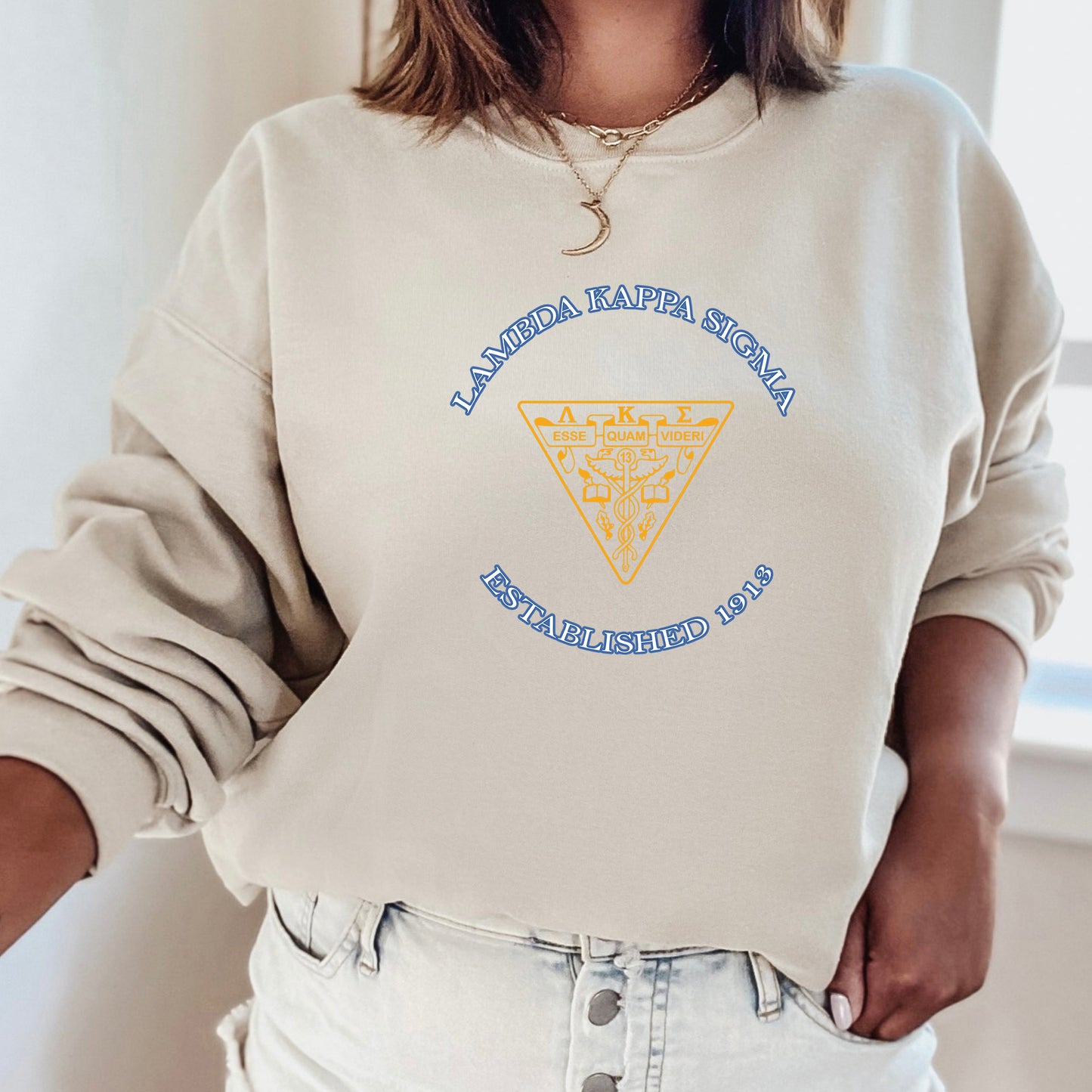 a woman wearing a sweatshirt with a triangle on it