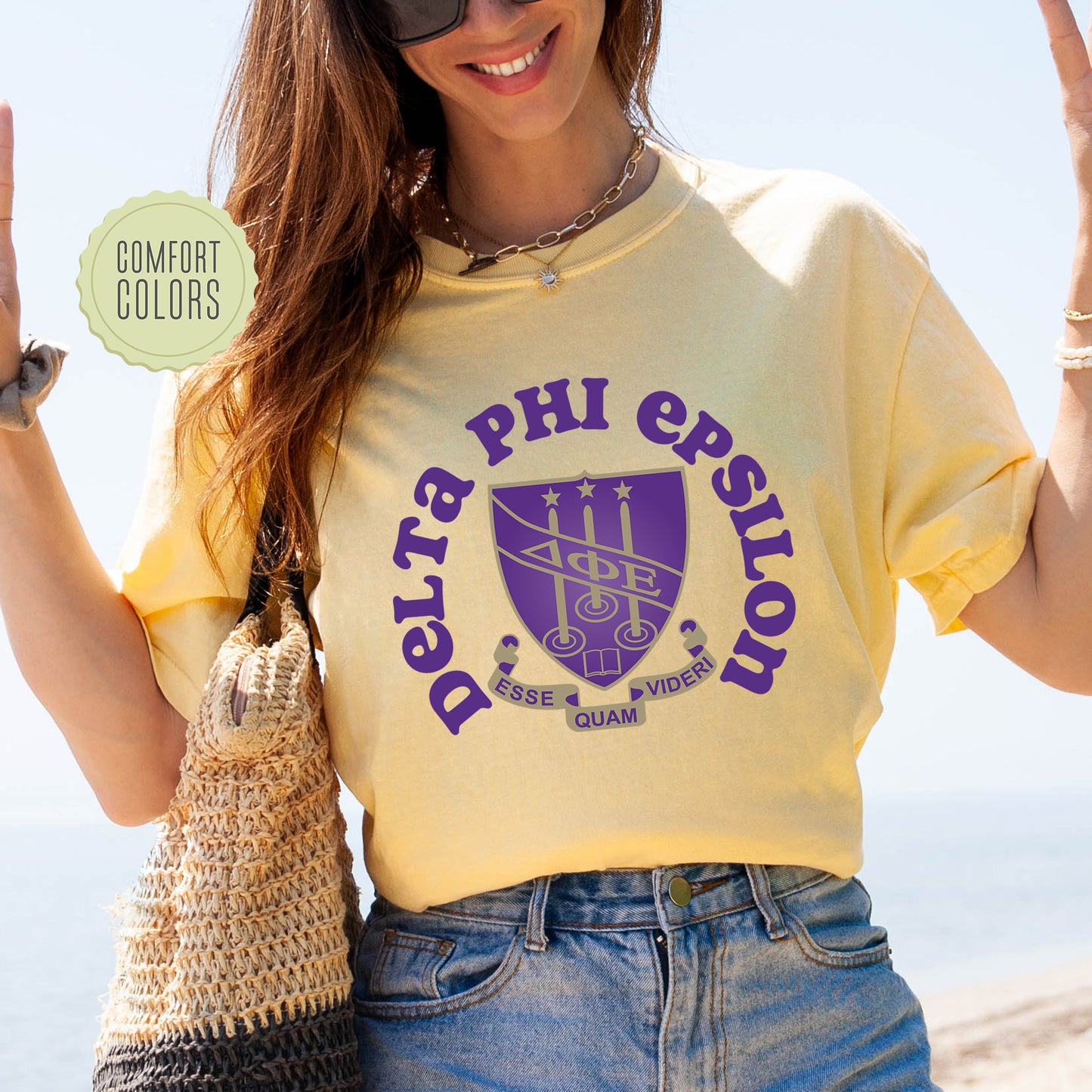 a woman in a yellow shirt is holding up a peace sign