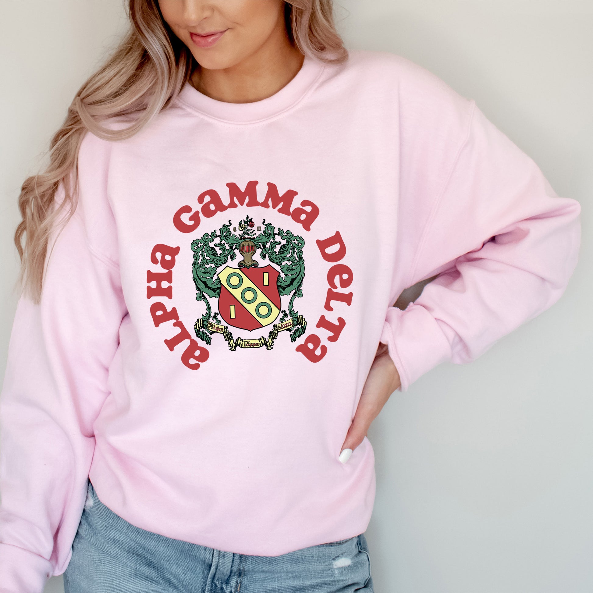 a woman wearing a pink sweatshirt and jeans