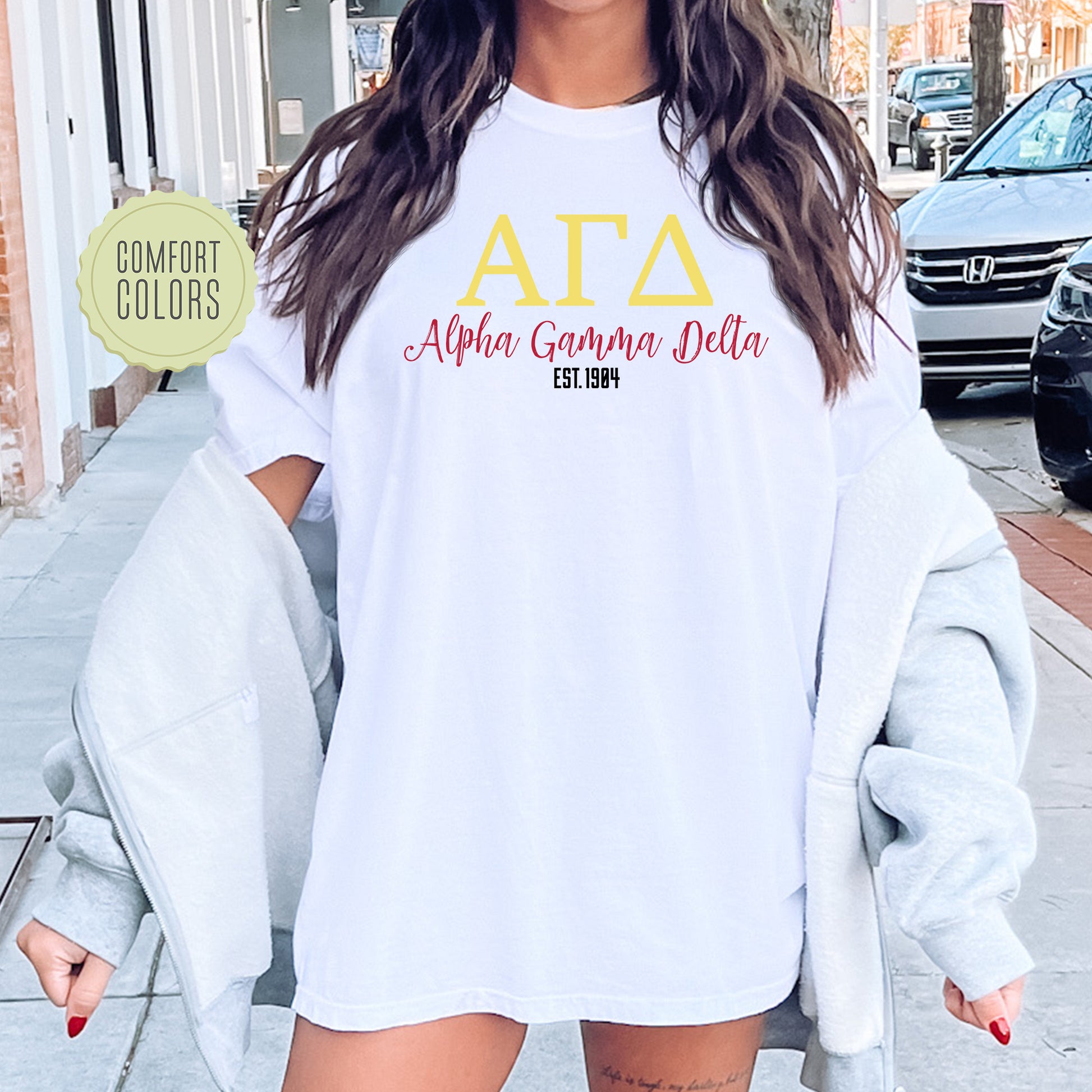 a woman wearing a white shirt with the letters ata on it