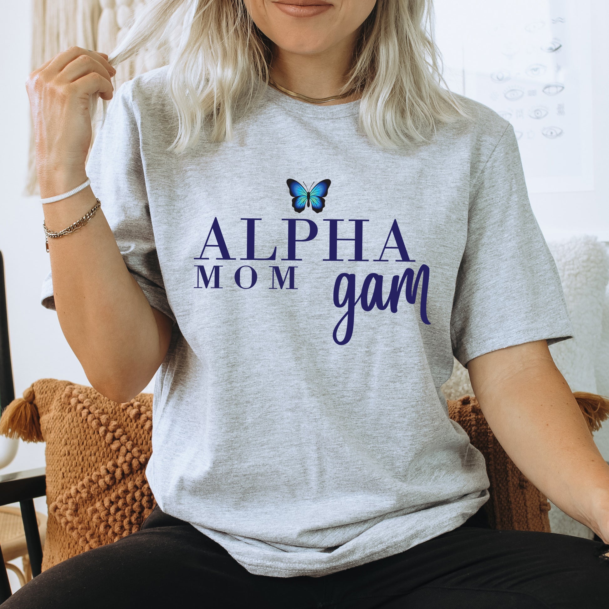 a woman sitting in a chair with a butterfly on her shirt