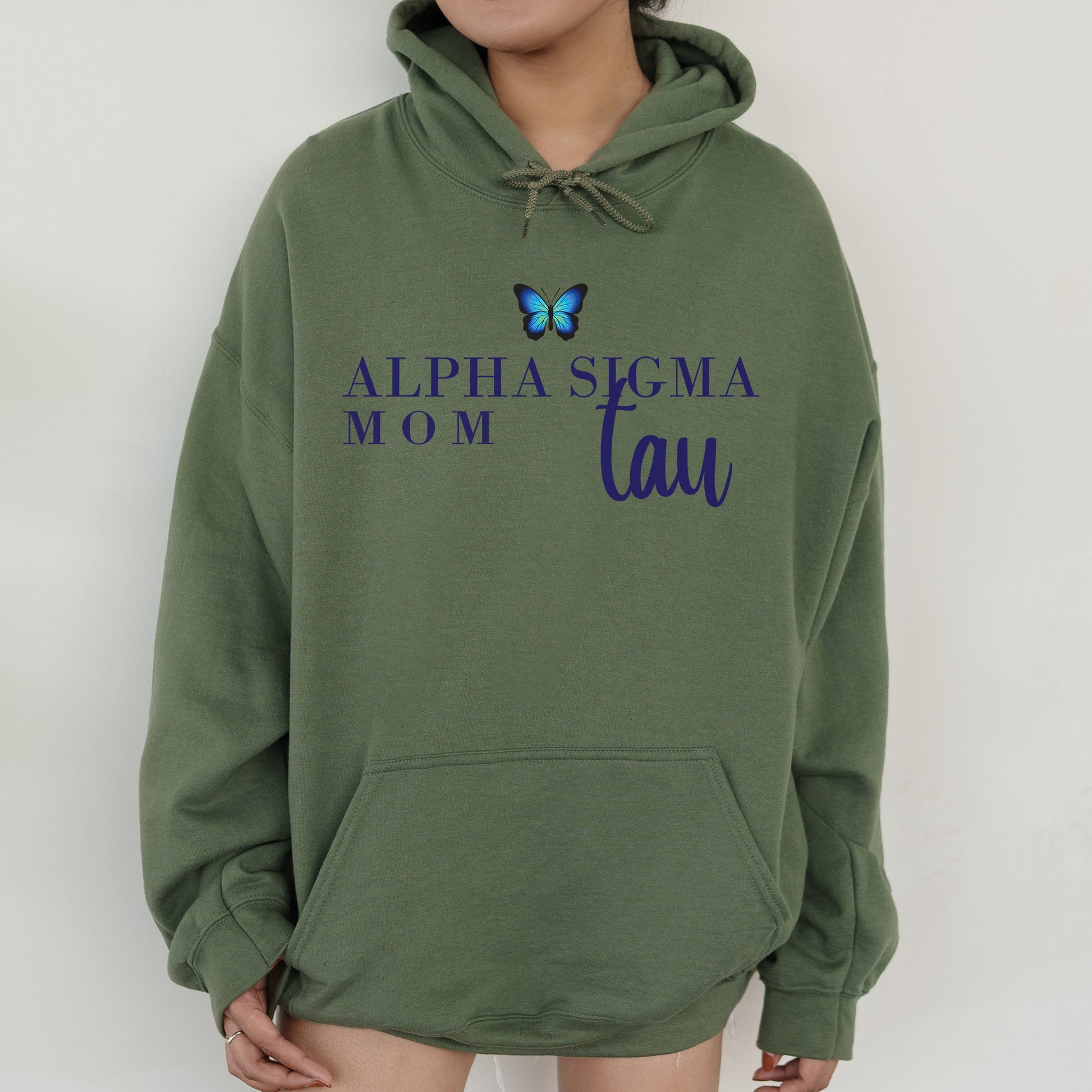 a woman wearing a green sweatshirt with a butterfly on it