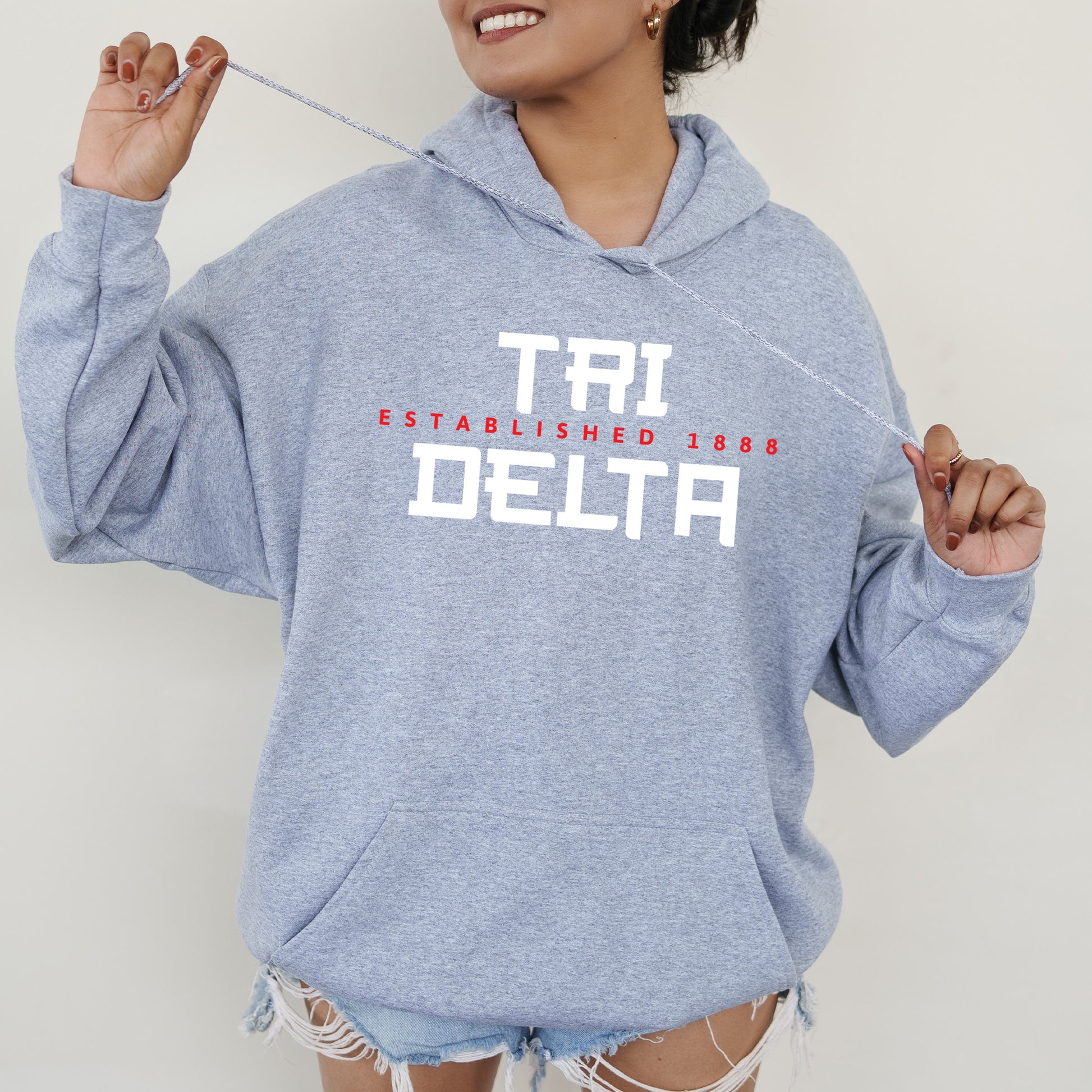 a woman in a blue hoodie holding a toothbrush