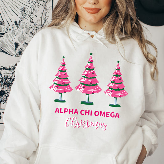 a woman wearing a white hoodie with pink christmas trees on it