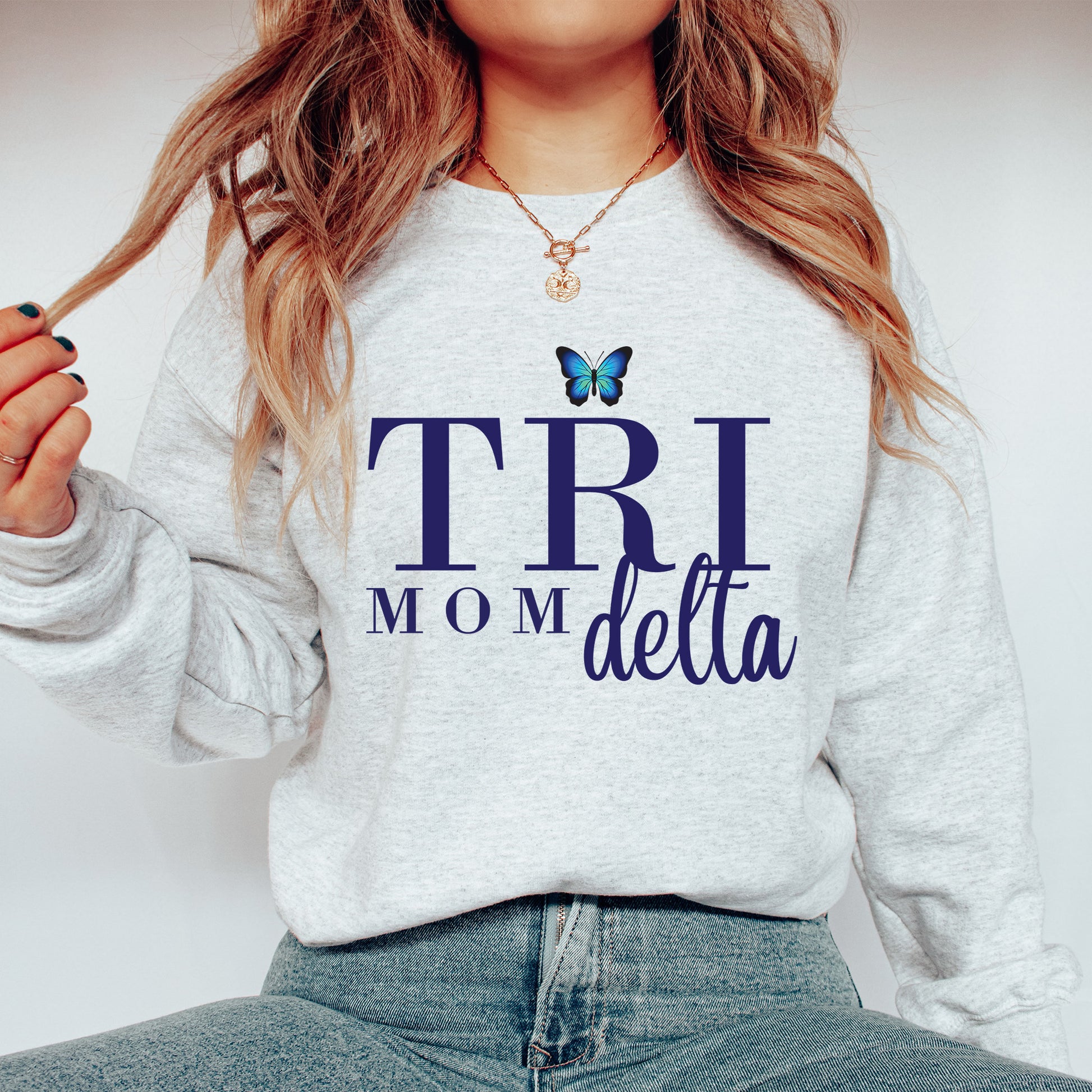 a woman wearing a sweatshirt with a butterfly on it