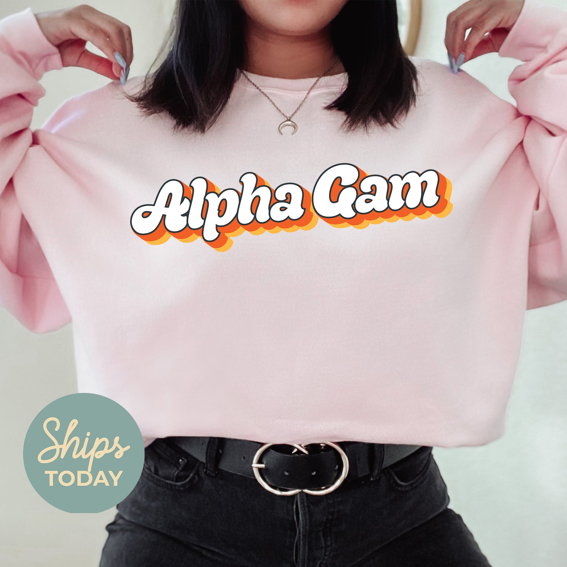 a woman wearing a pink sweatshirt with the words hipa cam on it