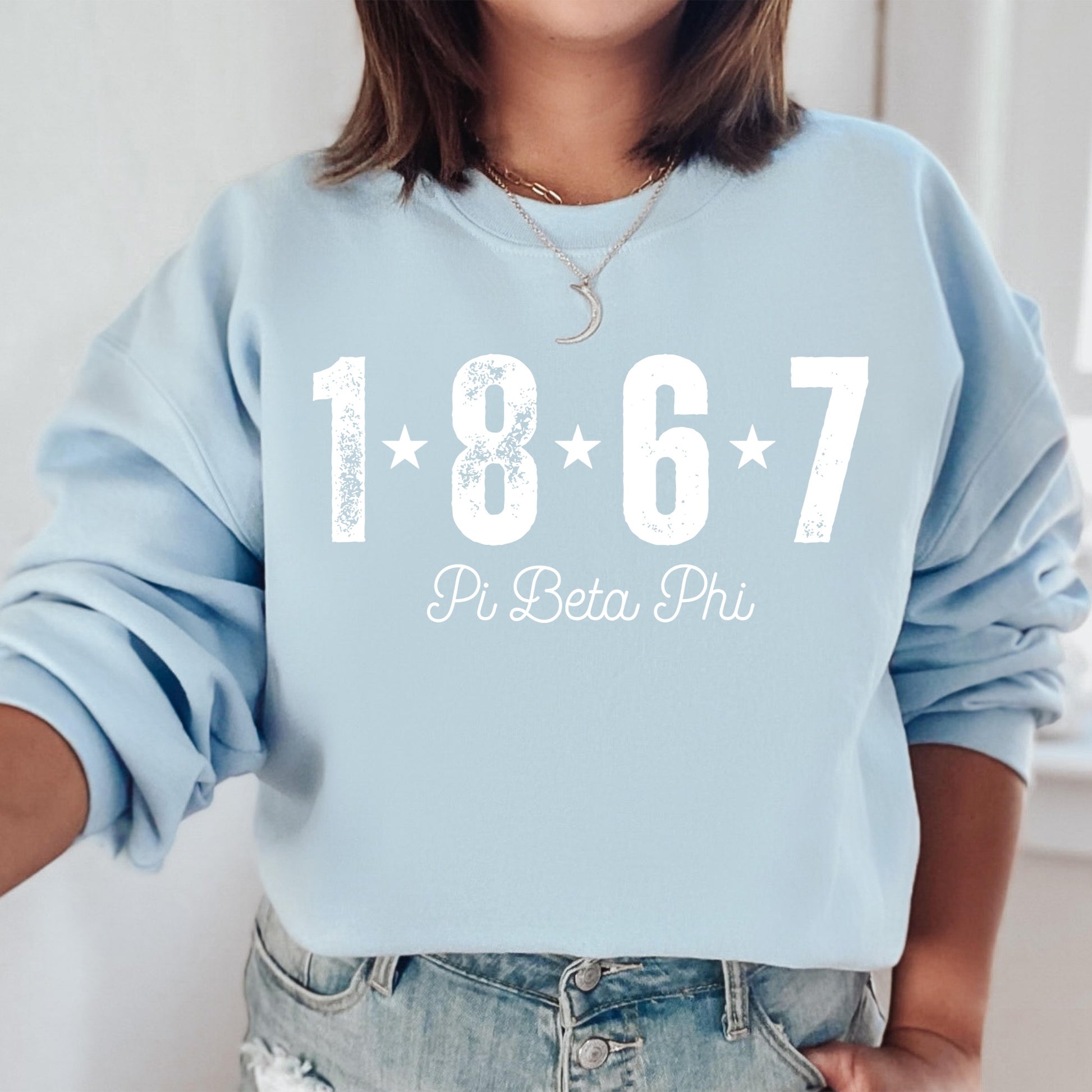 a woman wearing a blue sweatshirt with the year 1876 printed on it