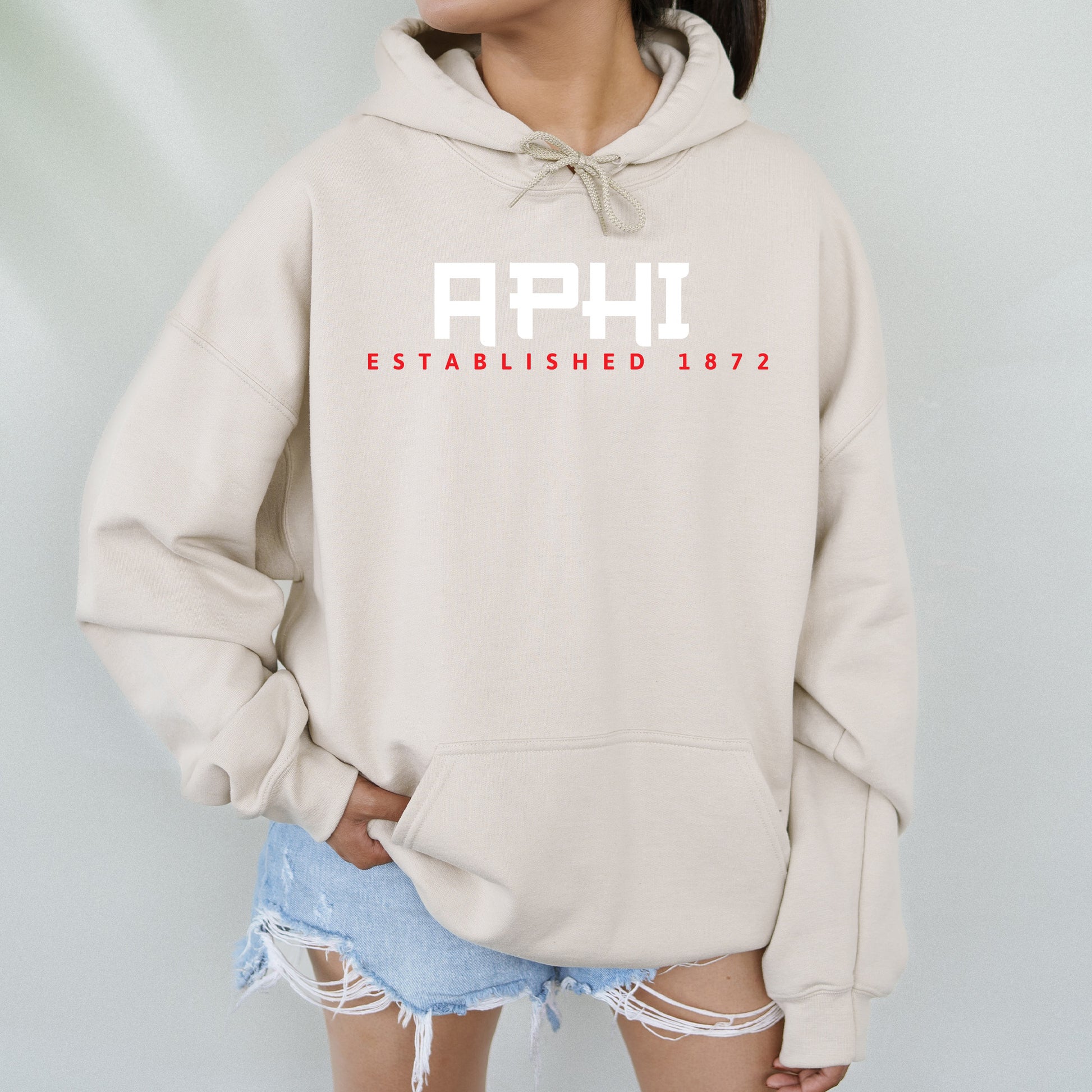 a woman wearing a sweatshirt with the words aphi on it