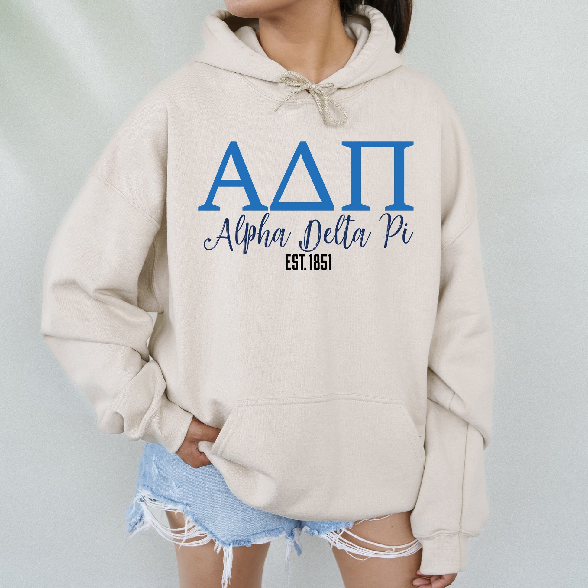 a woman wearing a hoodie with the letters aati on it