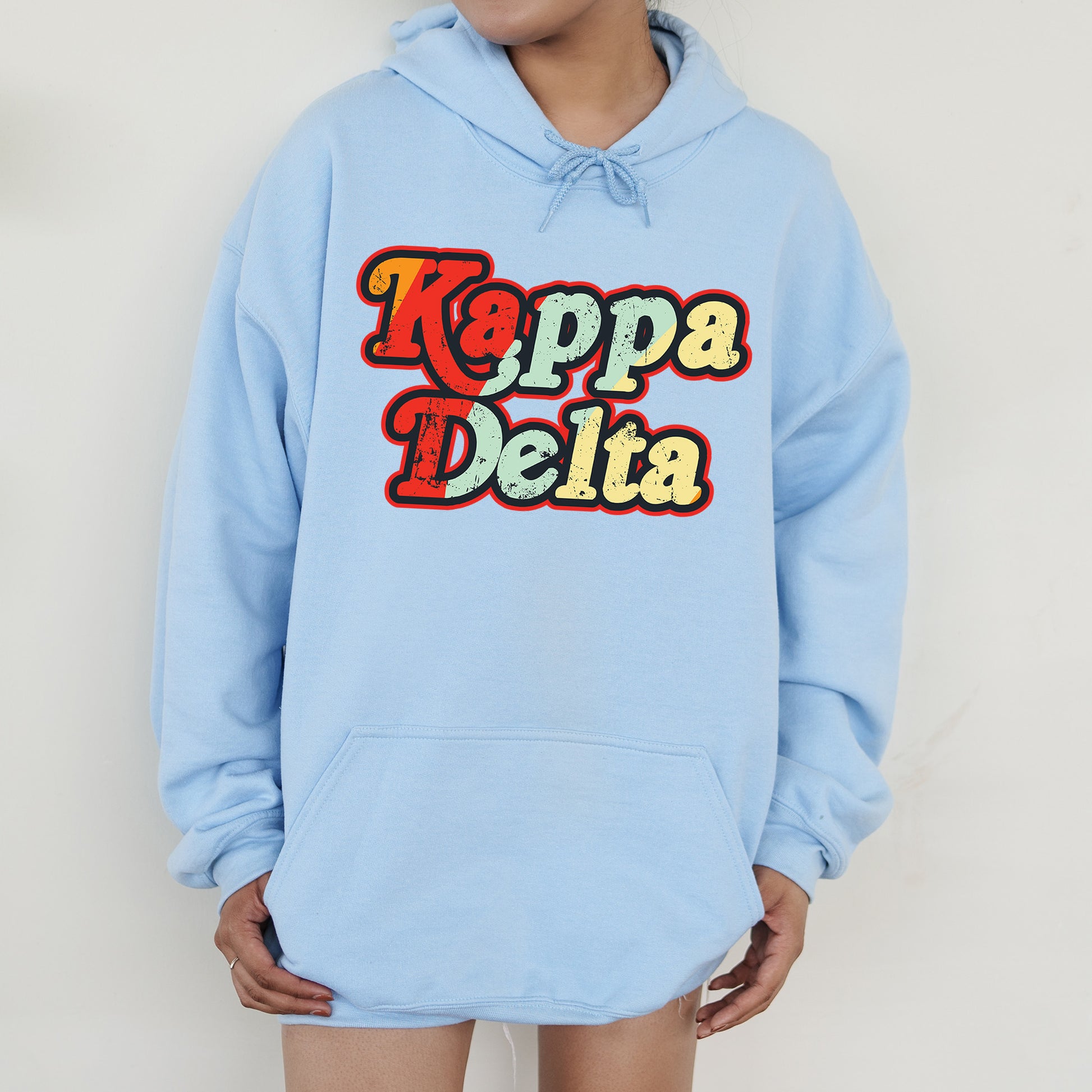 a person wearing a blue hoodie that says kappa delia