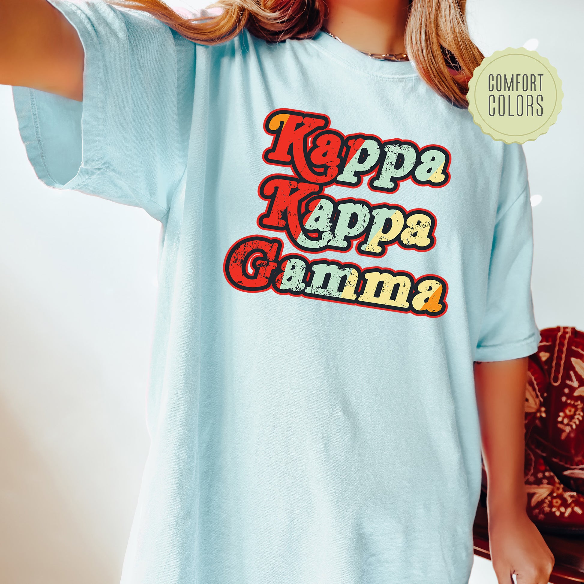 a woman wearing a blue shirt with the words kapa kapa gama on