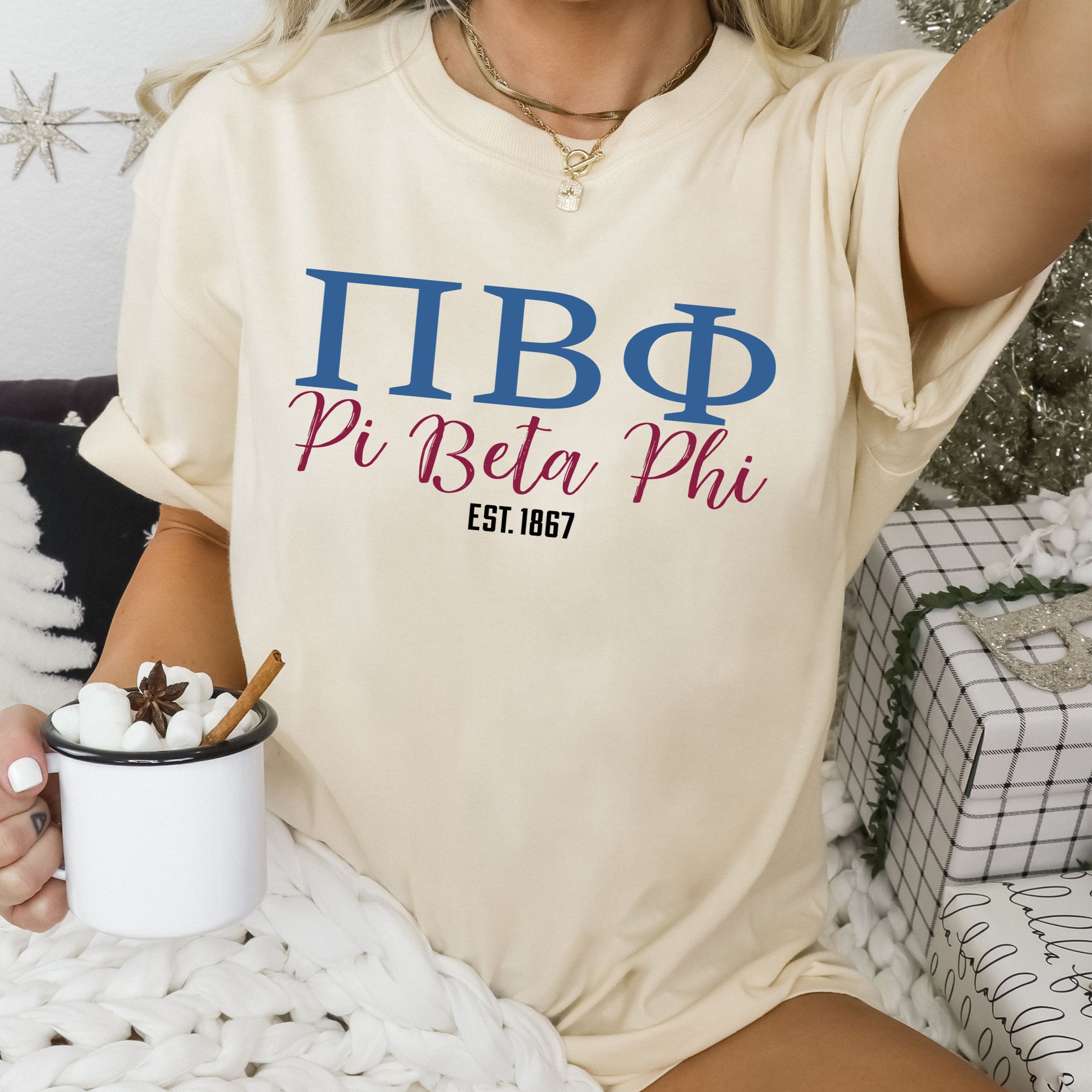 a woman sitting on a bed holding a cup of coffee
