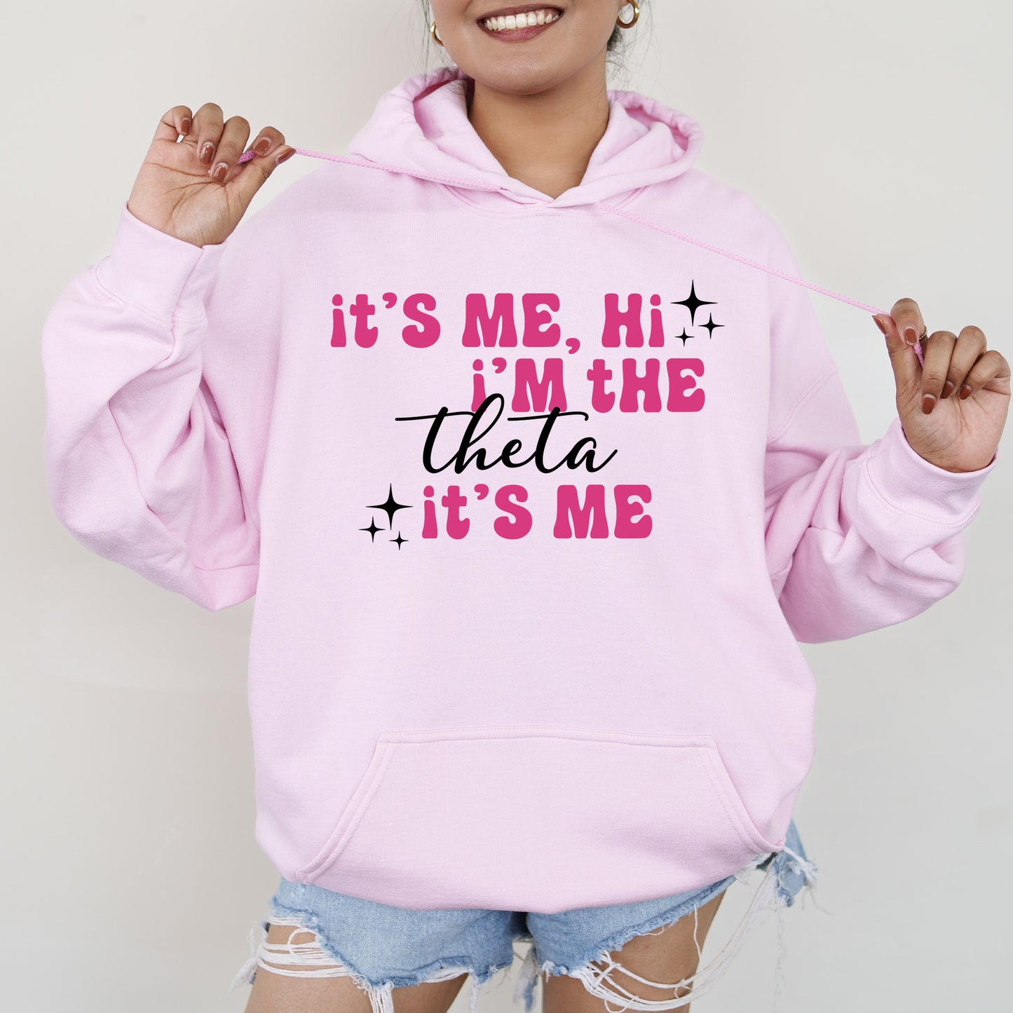 a woman wearing a pink hoodie that says it's me, he '