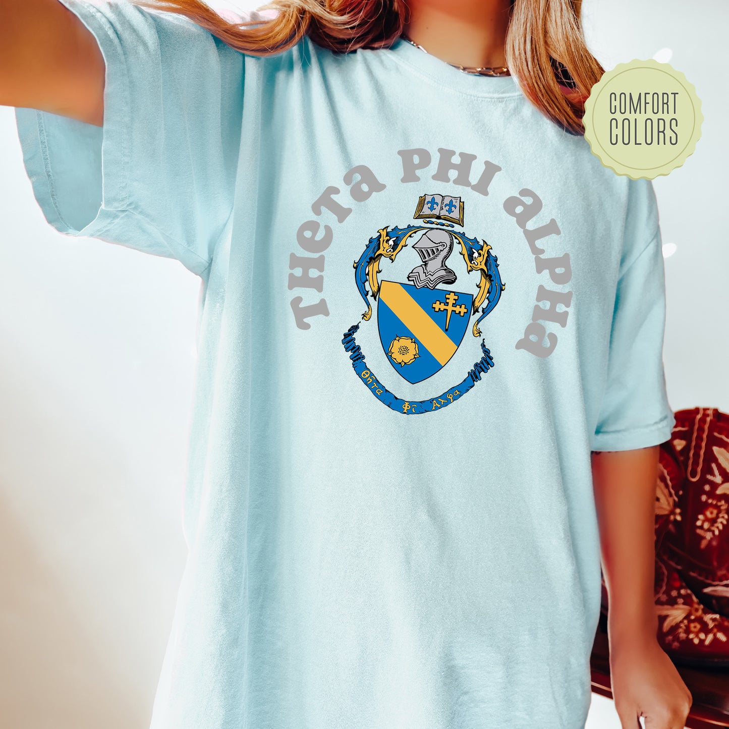 a young girl wearing a blue phi phi shirt