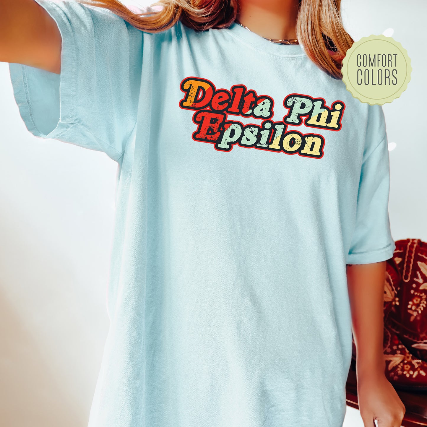 a woman wearing a blue shirt that says delta phi epiloon