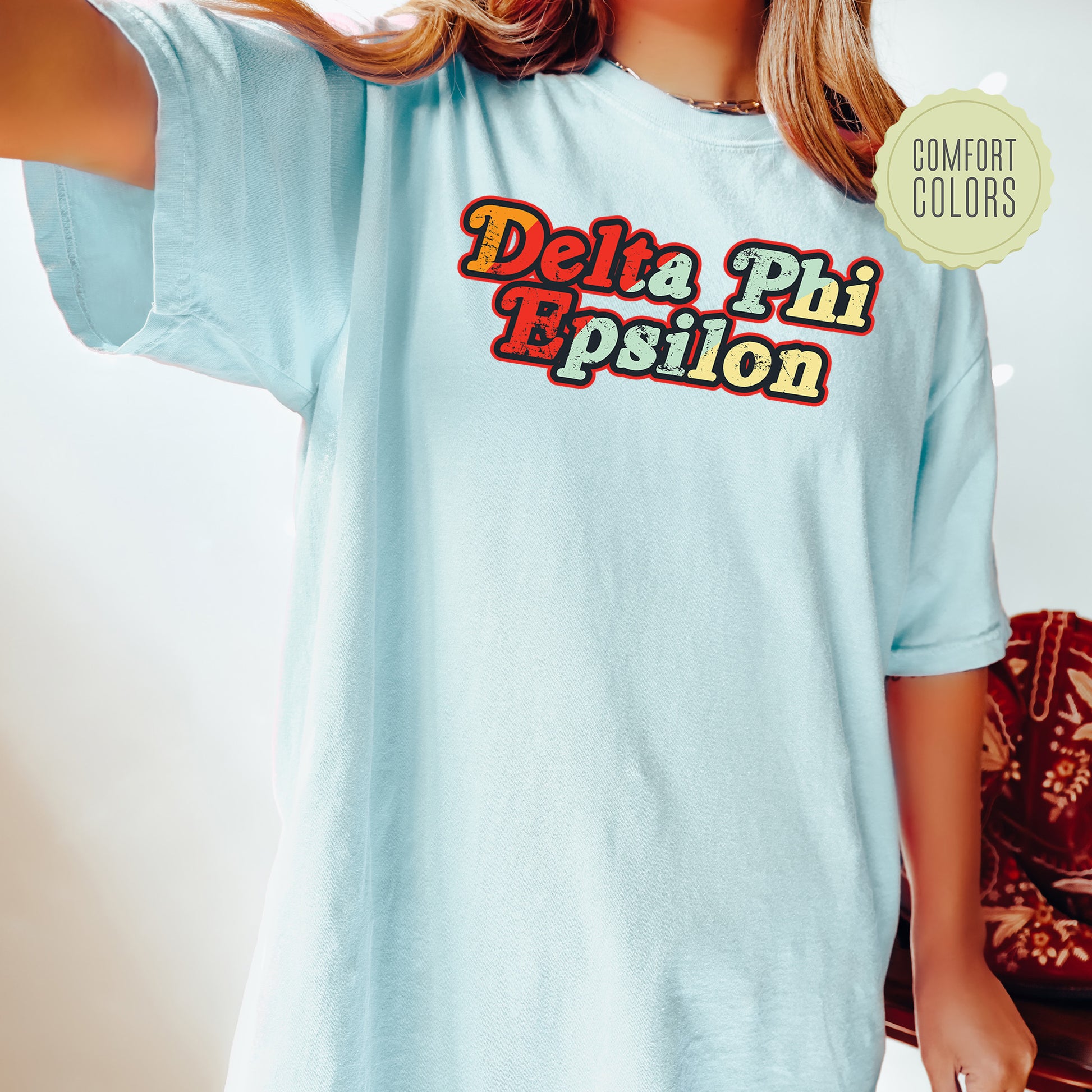 a woman wearing a blue shirt that says delta phi epiloon