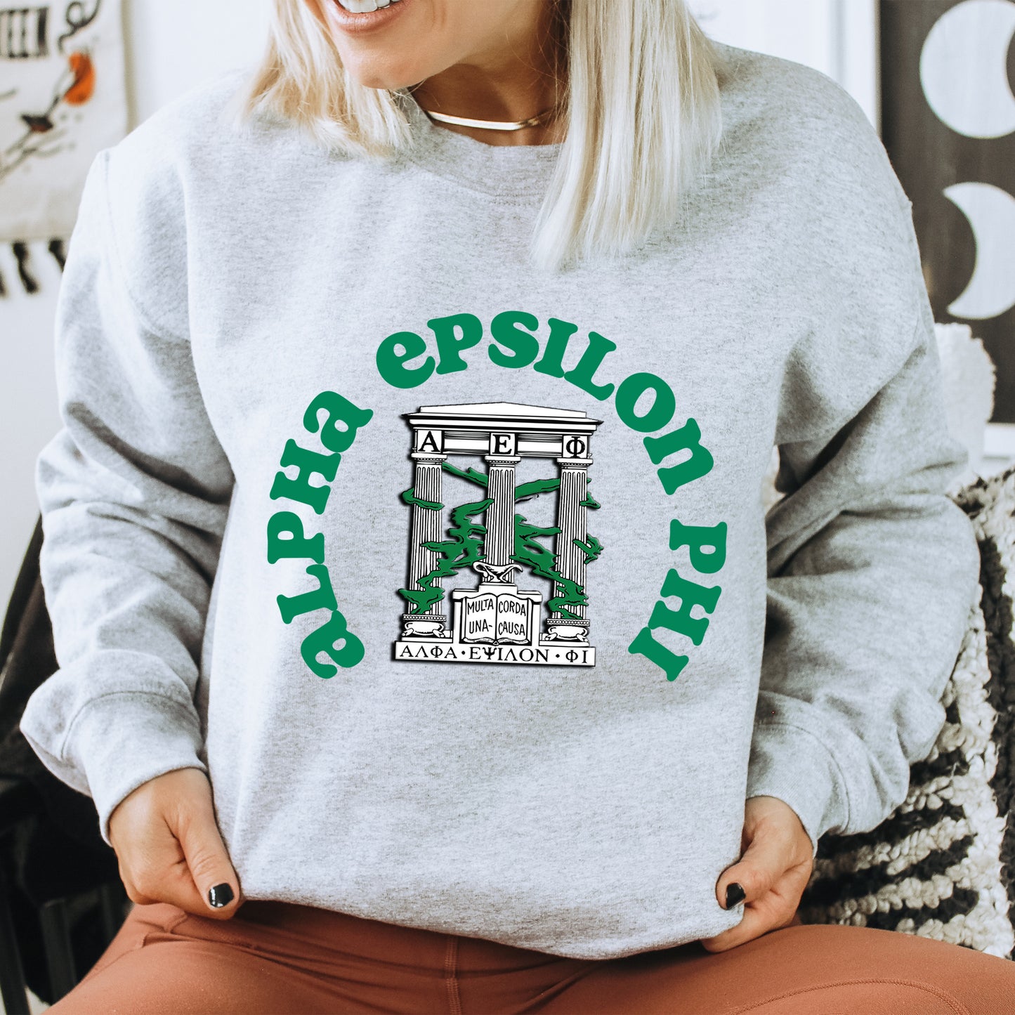 a woman sitting on a chair wearing a sweatshirt