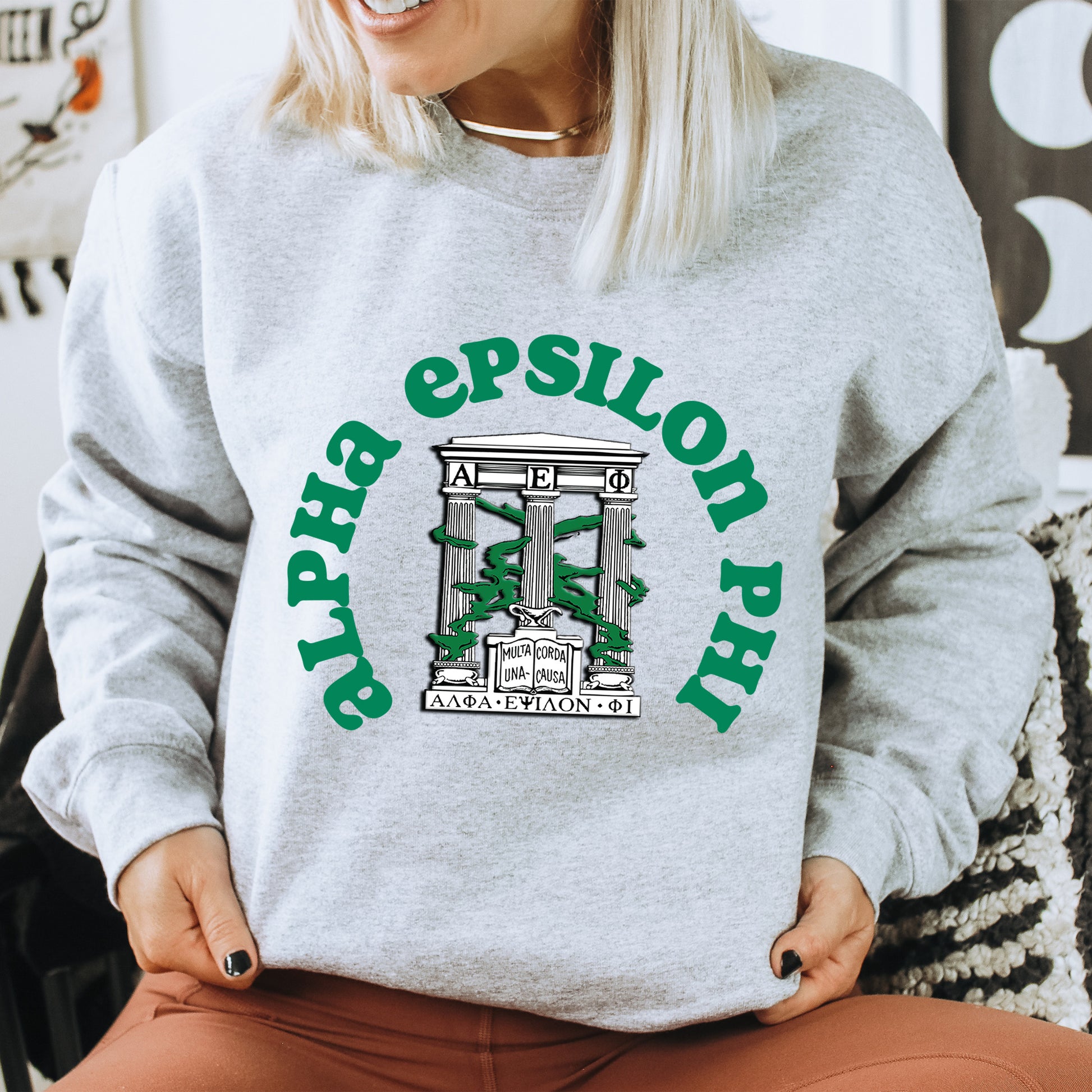 a woman sitting on a chair wearing a sweatshirt