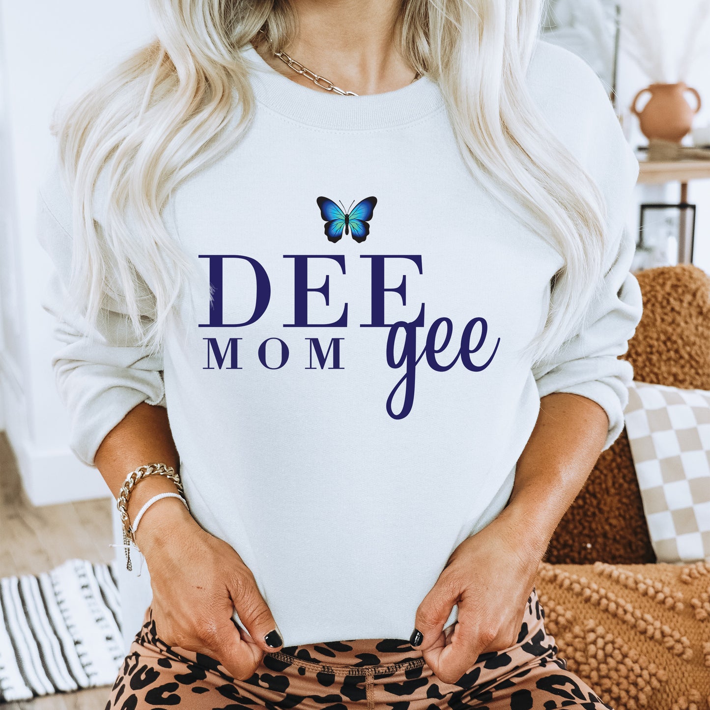 a woman wearing a sweatshirt with a butterfly on it