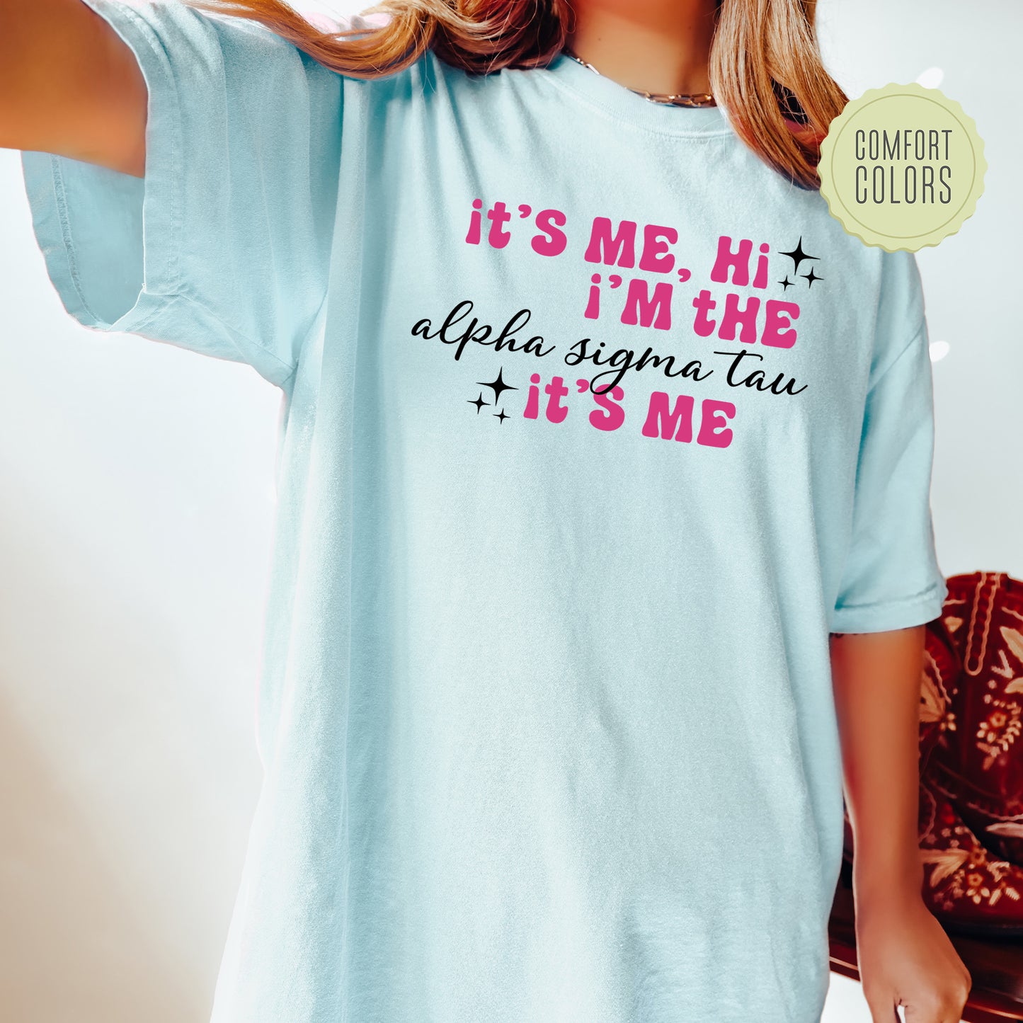 a woman wearing a light blue tshirt that says it's me,