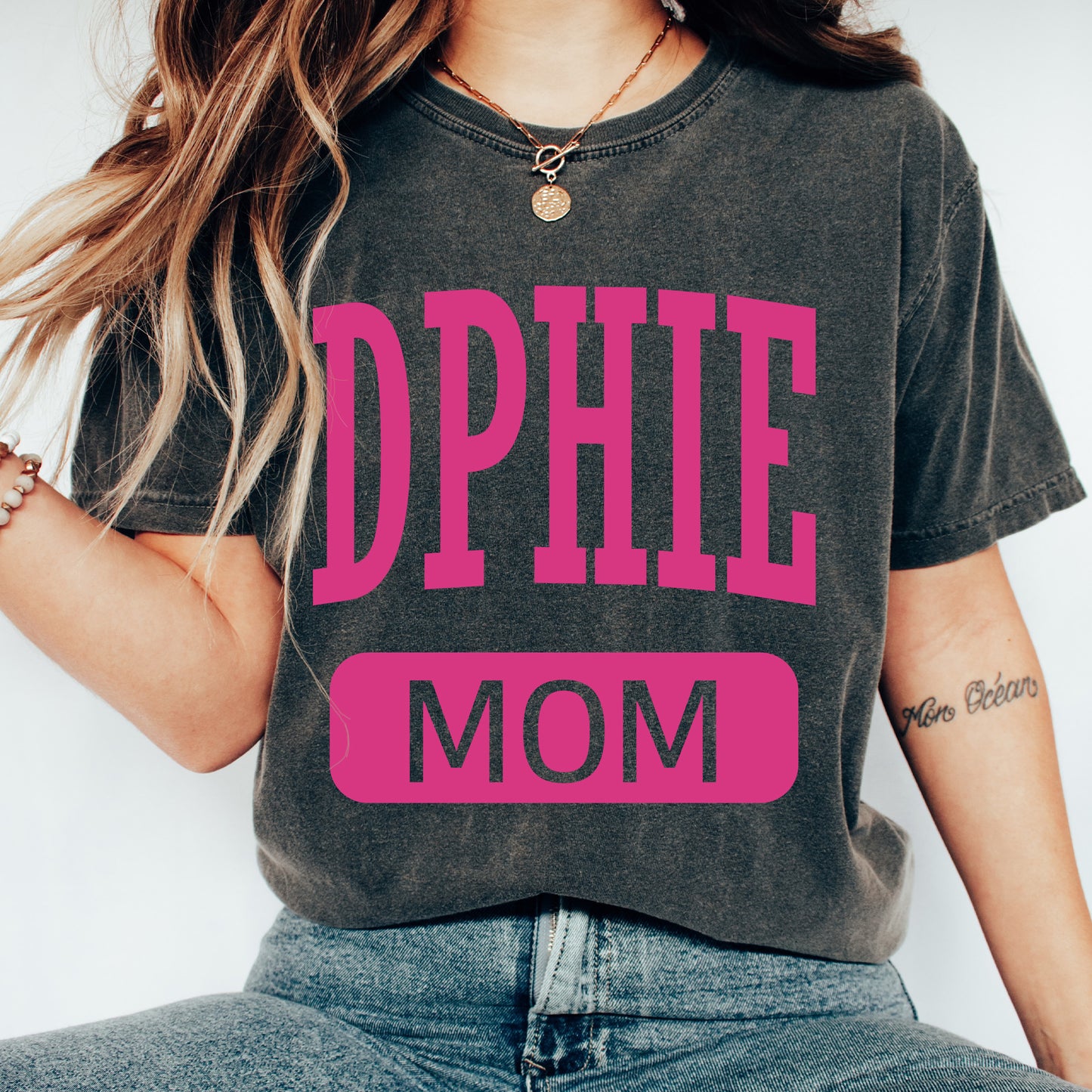 a woman wearing a black shirt with pink letters on it