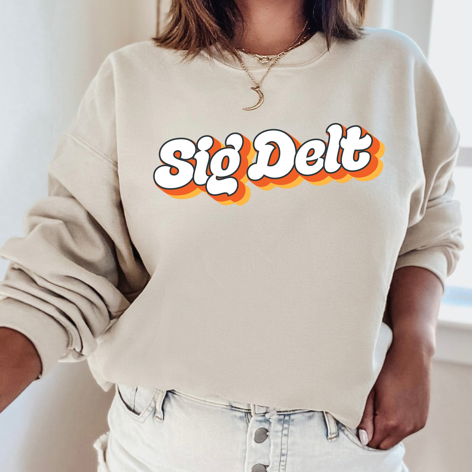 a woman wearing a sweatshirt that says sig delt
