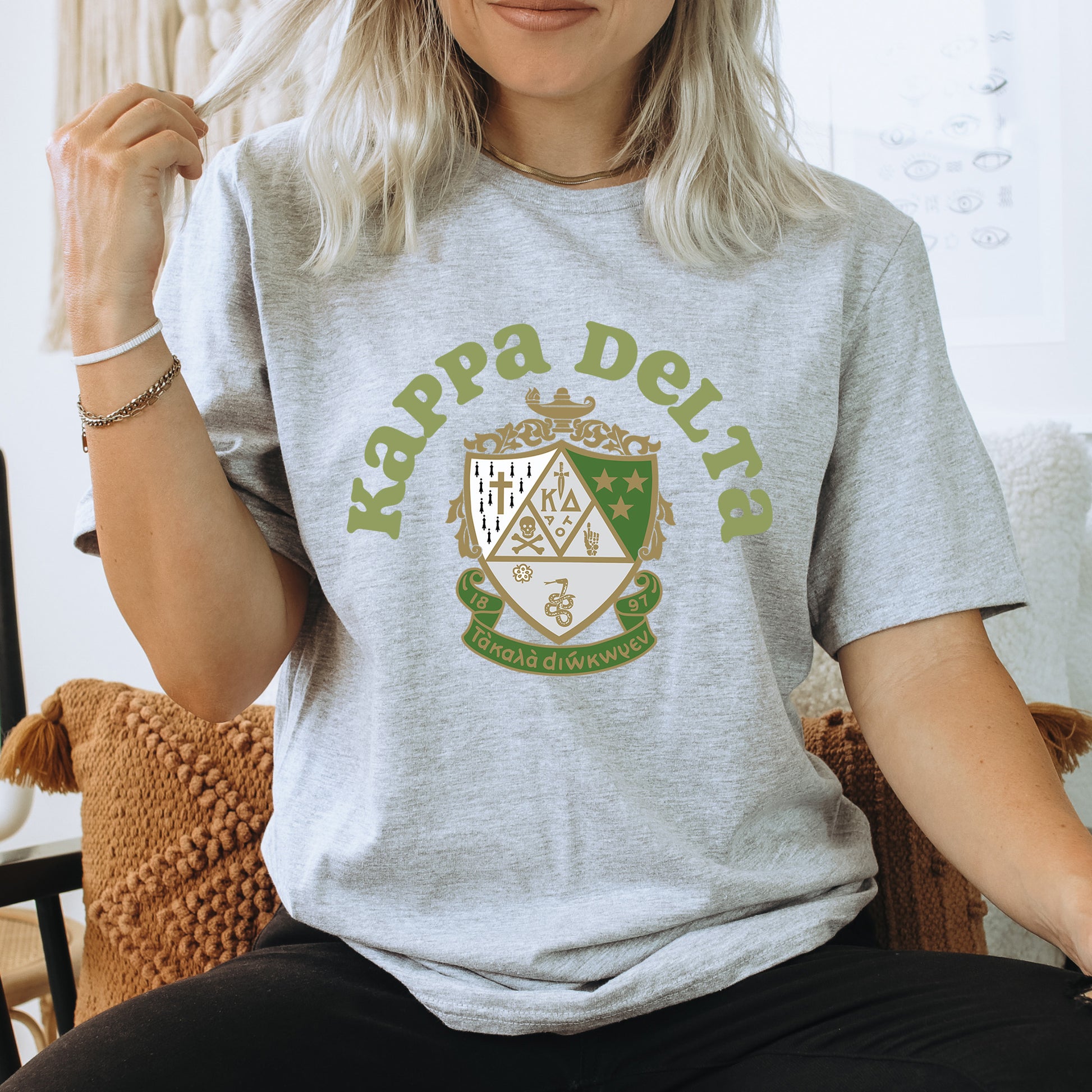 a woman sitting on a chair wearing a t - shirt that says kappea