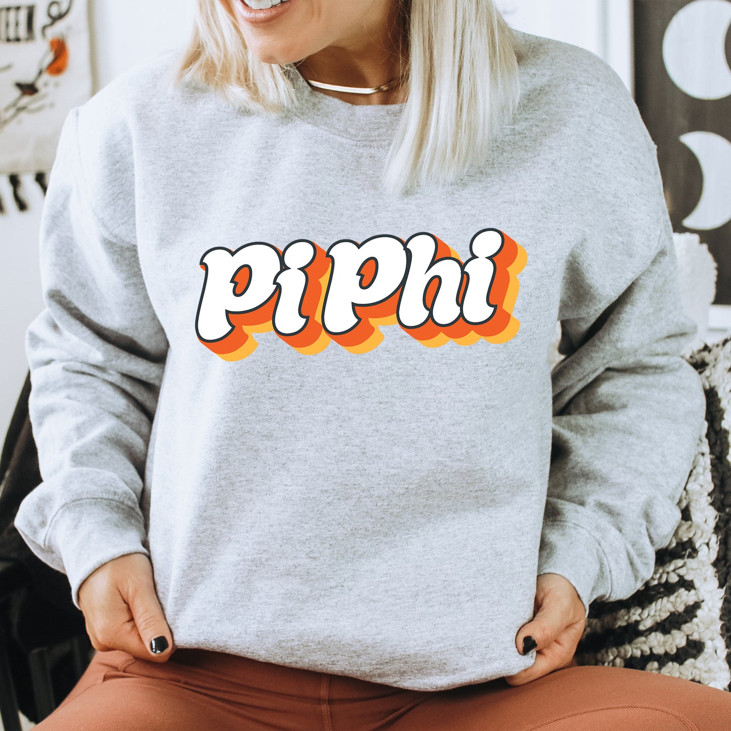 a woman wearing a grey sweatshirt with the word pippi on it