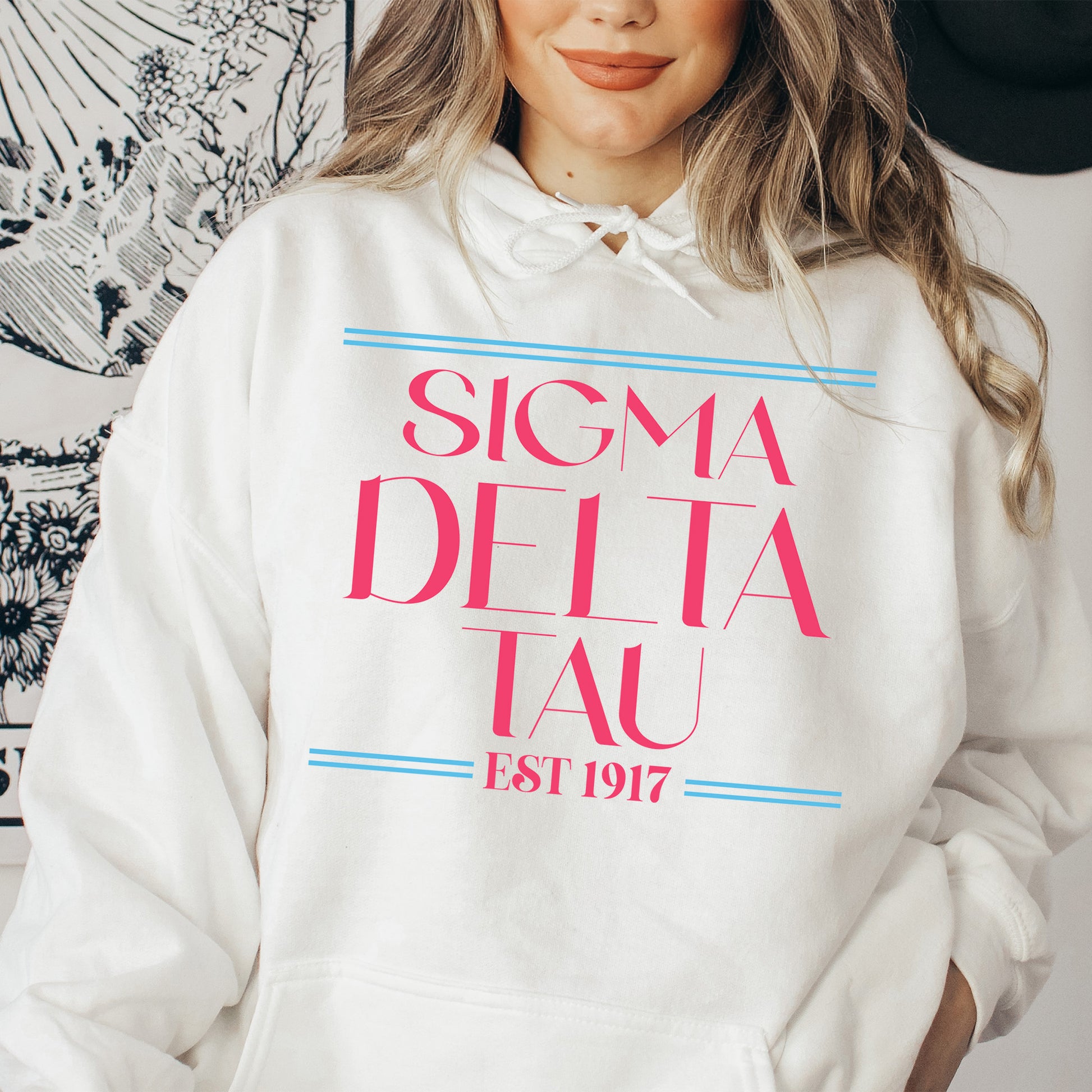 a woman wearing a white sweatshirt with a pink and blue graphic on it