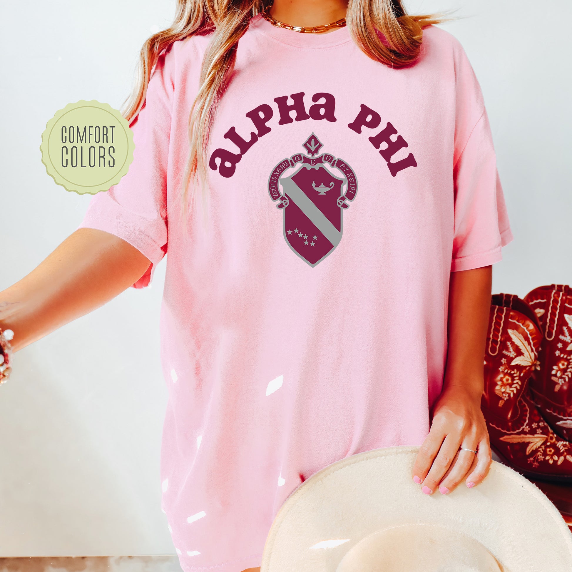a woman wearing a pink shirt and hat
