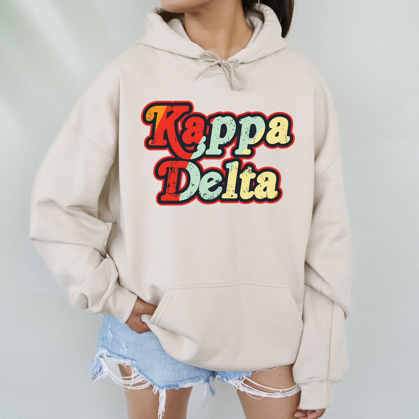 a woman wearing a hoodie that says kappa delta