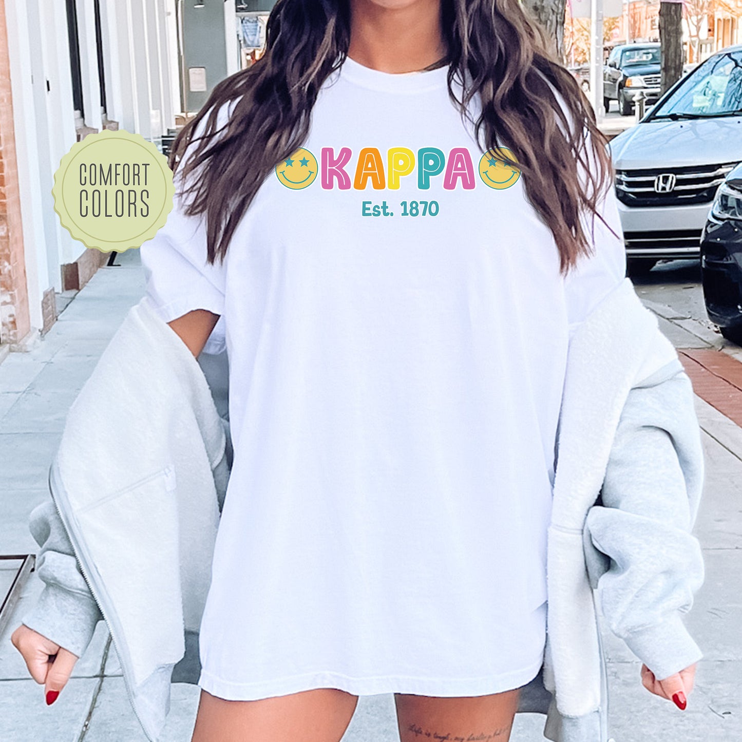 a woman wearing a white shirt with the word kappa on it