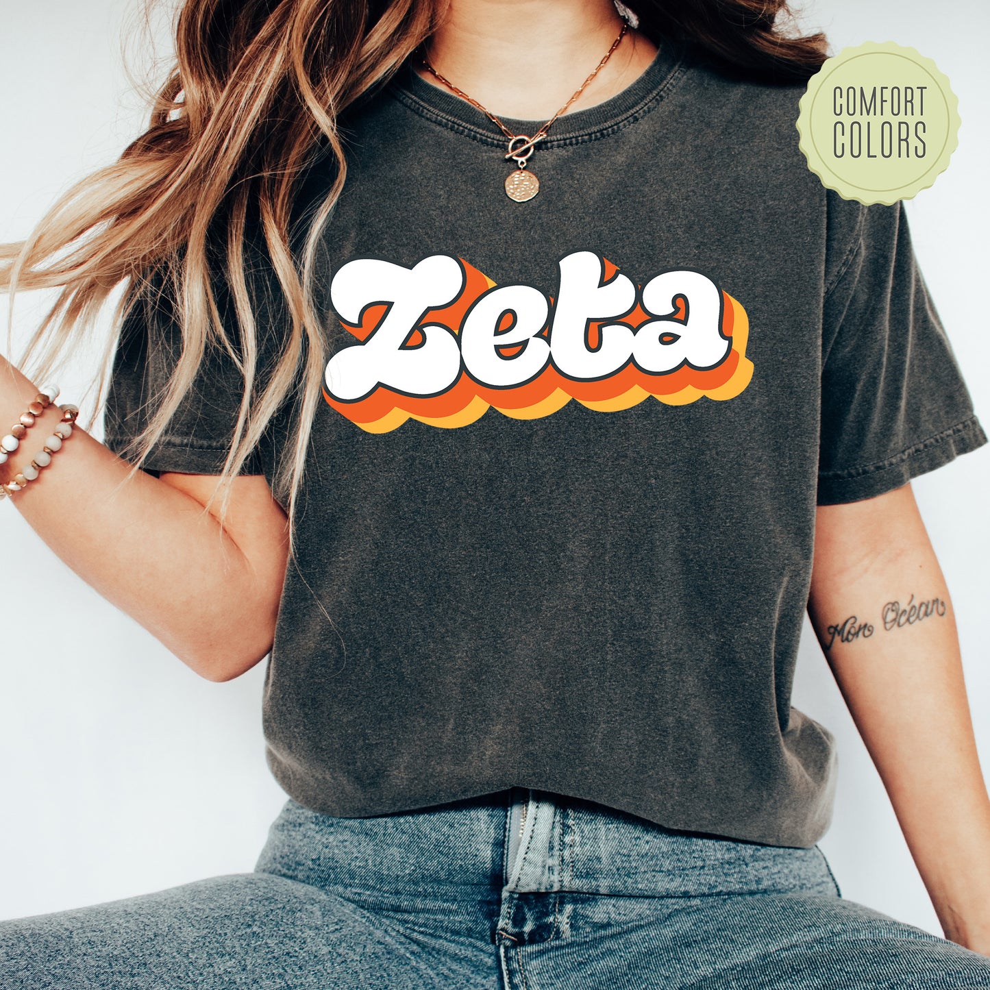 a woman wearing a black shirt with the word zeba on it