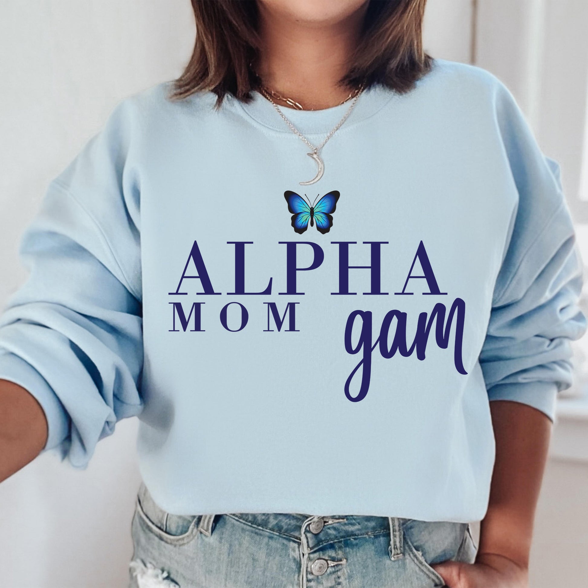a woman wearing a blue sweatshirt with a butterfly on it