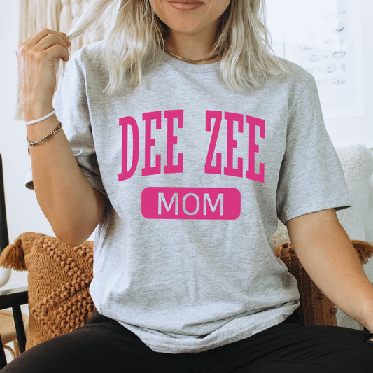 a woman wearing a tee shirt that says dee zeee mom
