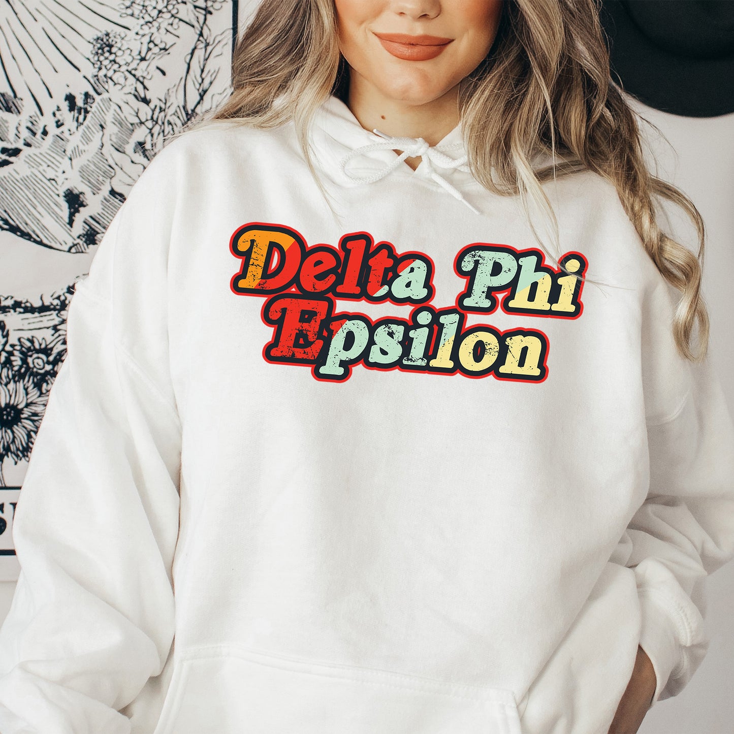 a woman wearing a white hoodie with the words delta phi prison on it