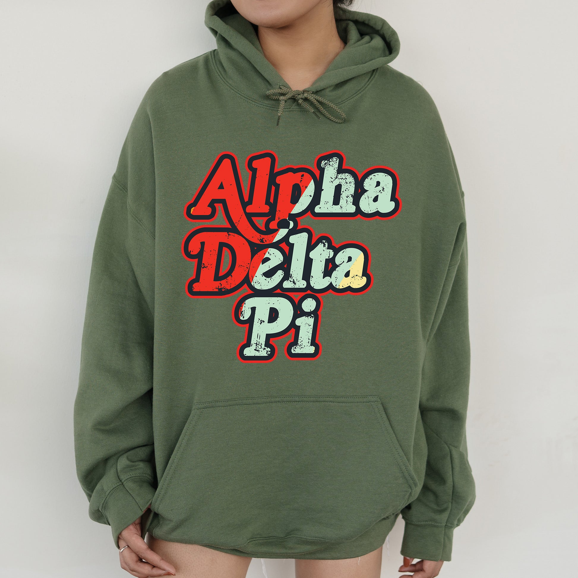 a woman wearing a green hoodie with the words aloh delta pi on it
