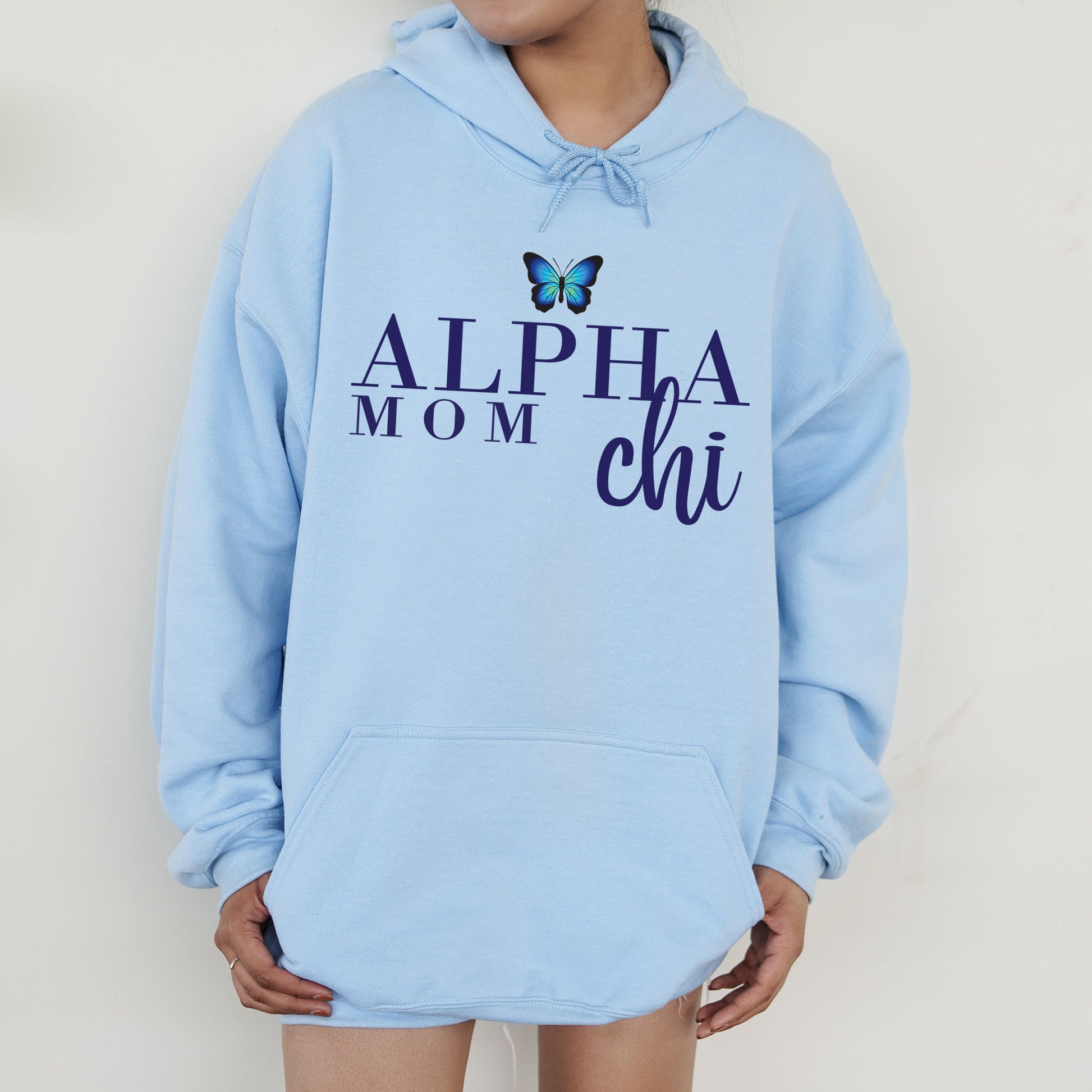 a woman wearing a blue hoodie with a butterfly on it